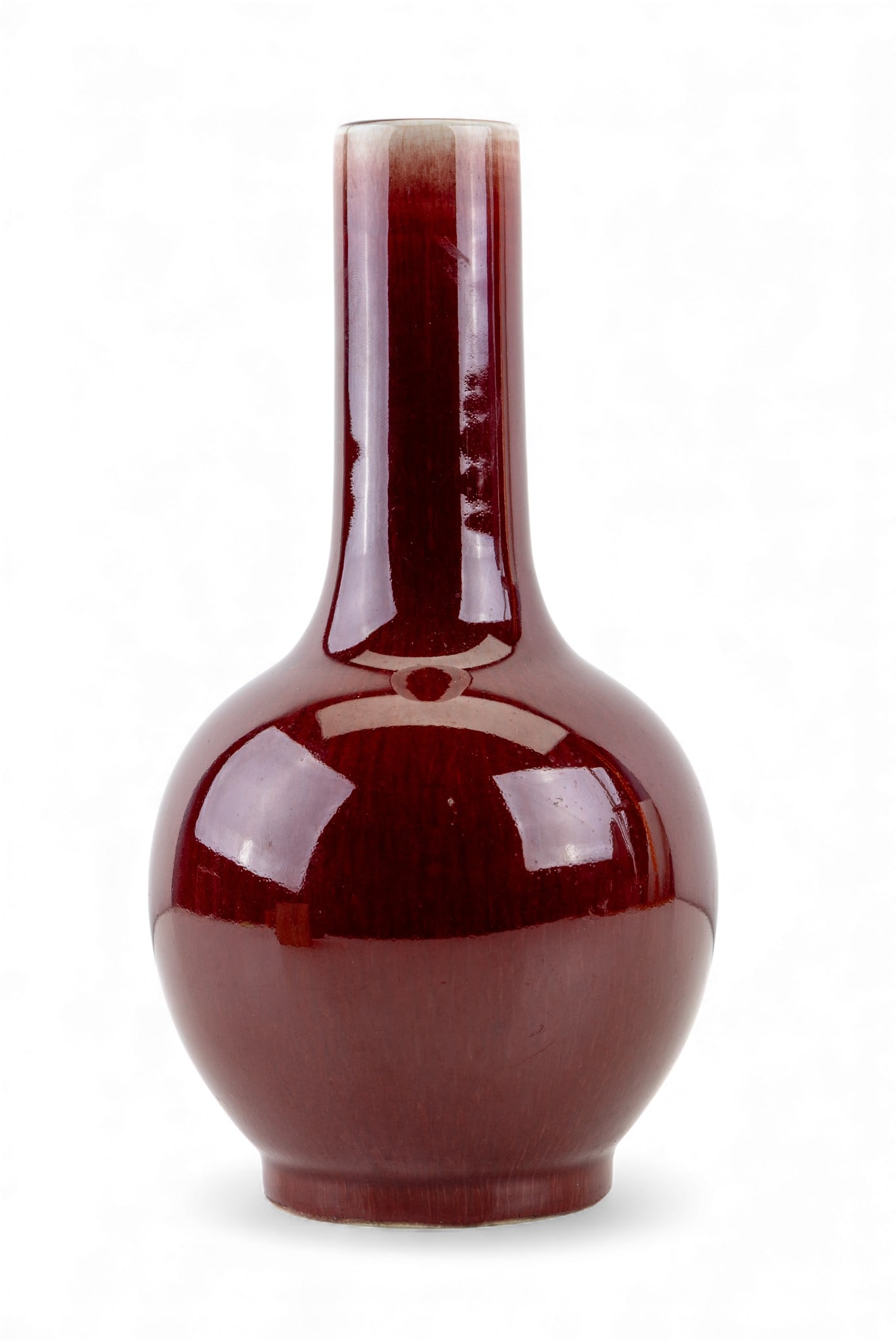 Chinese Oxblood Vase: Bottle form vase with oxblood glaze. Measures approx. 9.5" H.