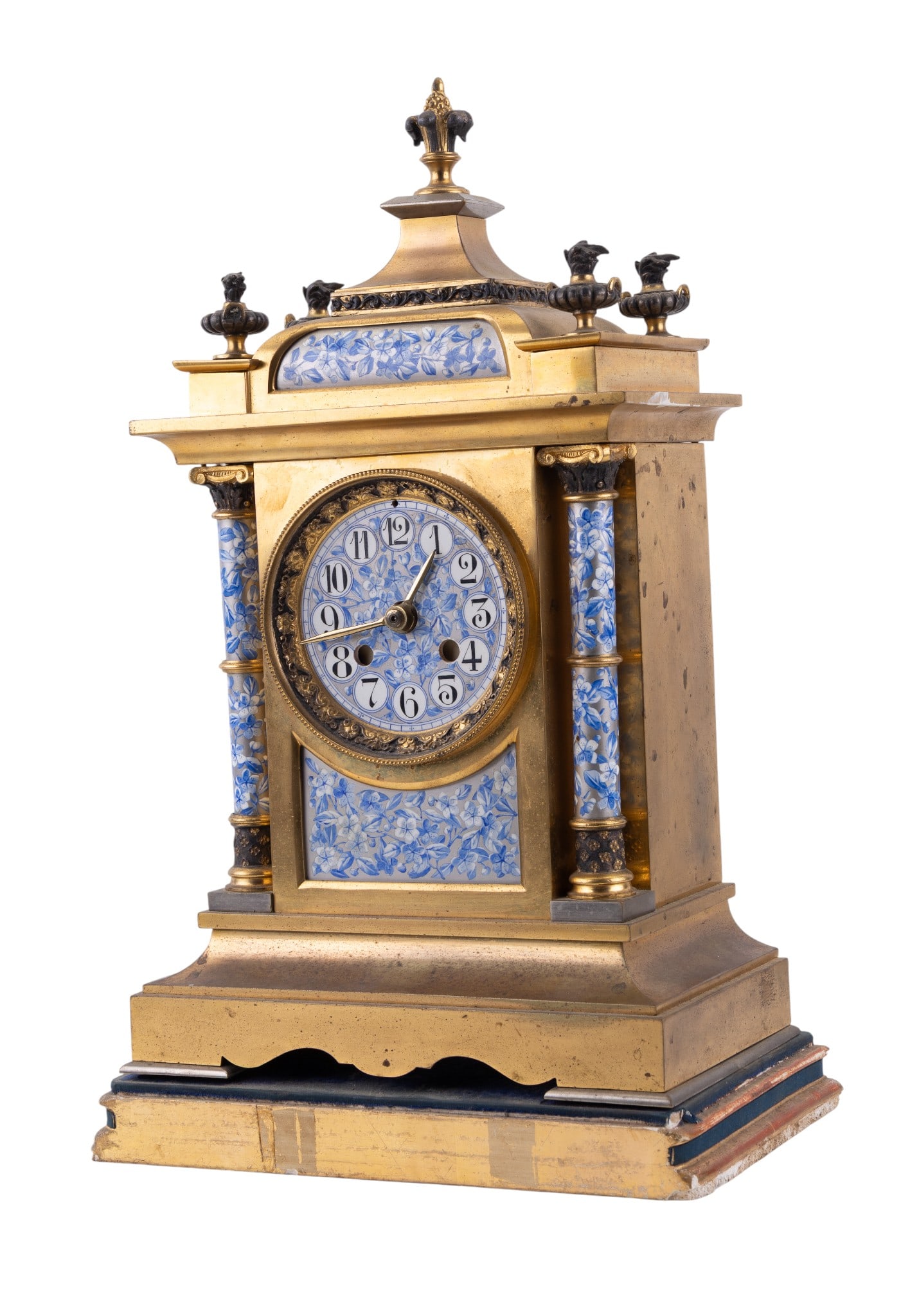 French Gilt Bronze & Porcelain Mantel Clock: Late 19th Century French gilt bronze mantel clock featuring rich blue and white floral porcelain panels and dial, flanked by twin columns and surmounted by urn finials. Fitted with a later Dial Corp.
