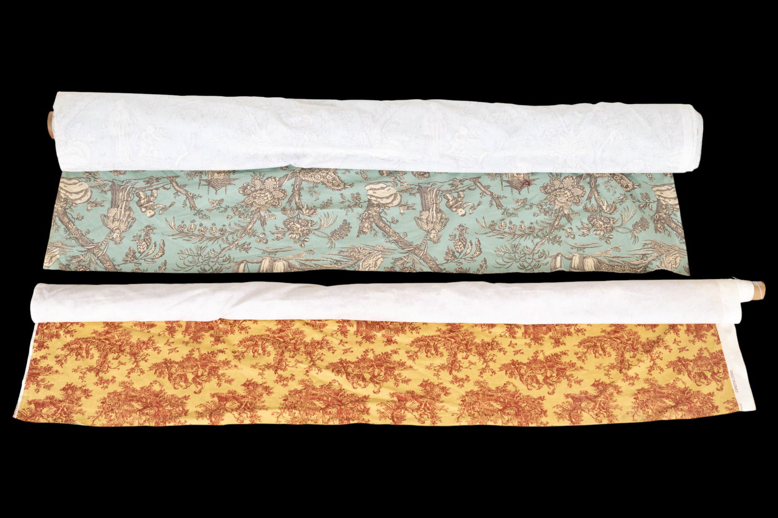 Colonial Williamsburg Fabric Bolts: Two bolts of Colonial Williamsburg cotton twill fabric including a bolt featuring a light blue-green Chinoiserie print (approx. 35'), and a bolt of a red and gold Colonial print (approx. 10').