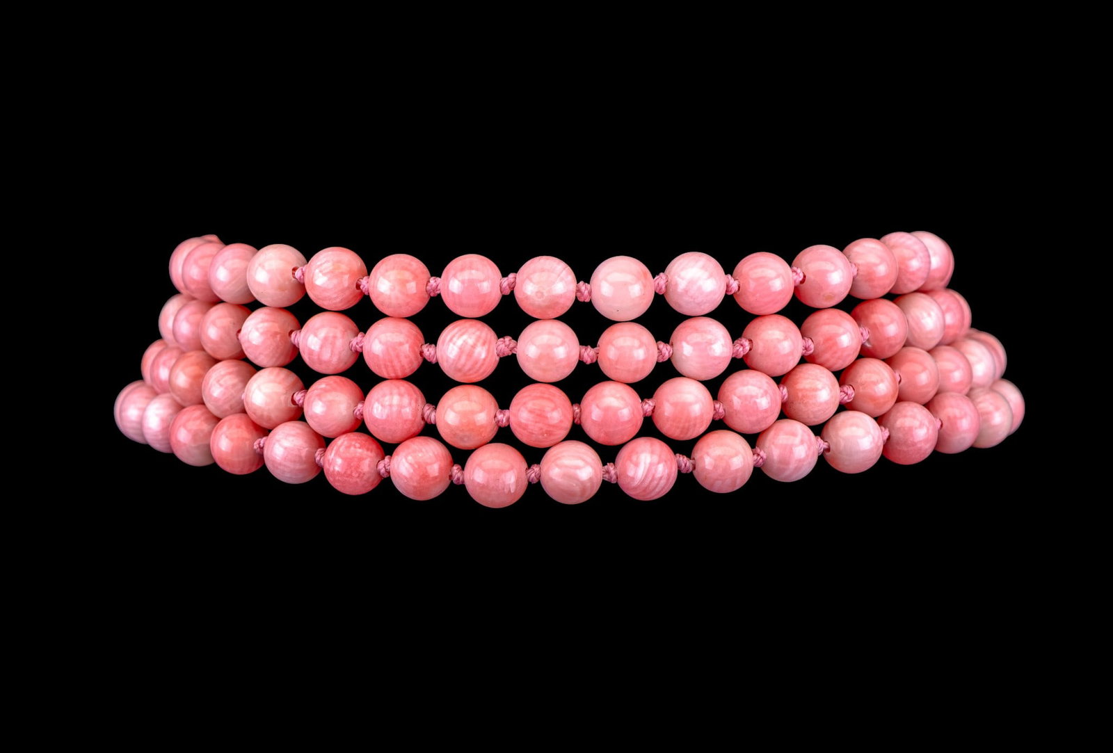 Vivid Pink Coral Bead Strand: Fine polished and vivid pink strand of spherical coral beads,. Measures approx. 50" L. No clasp, one long necklace.