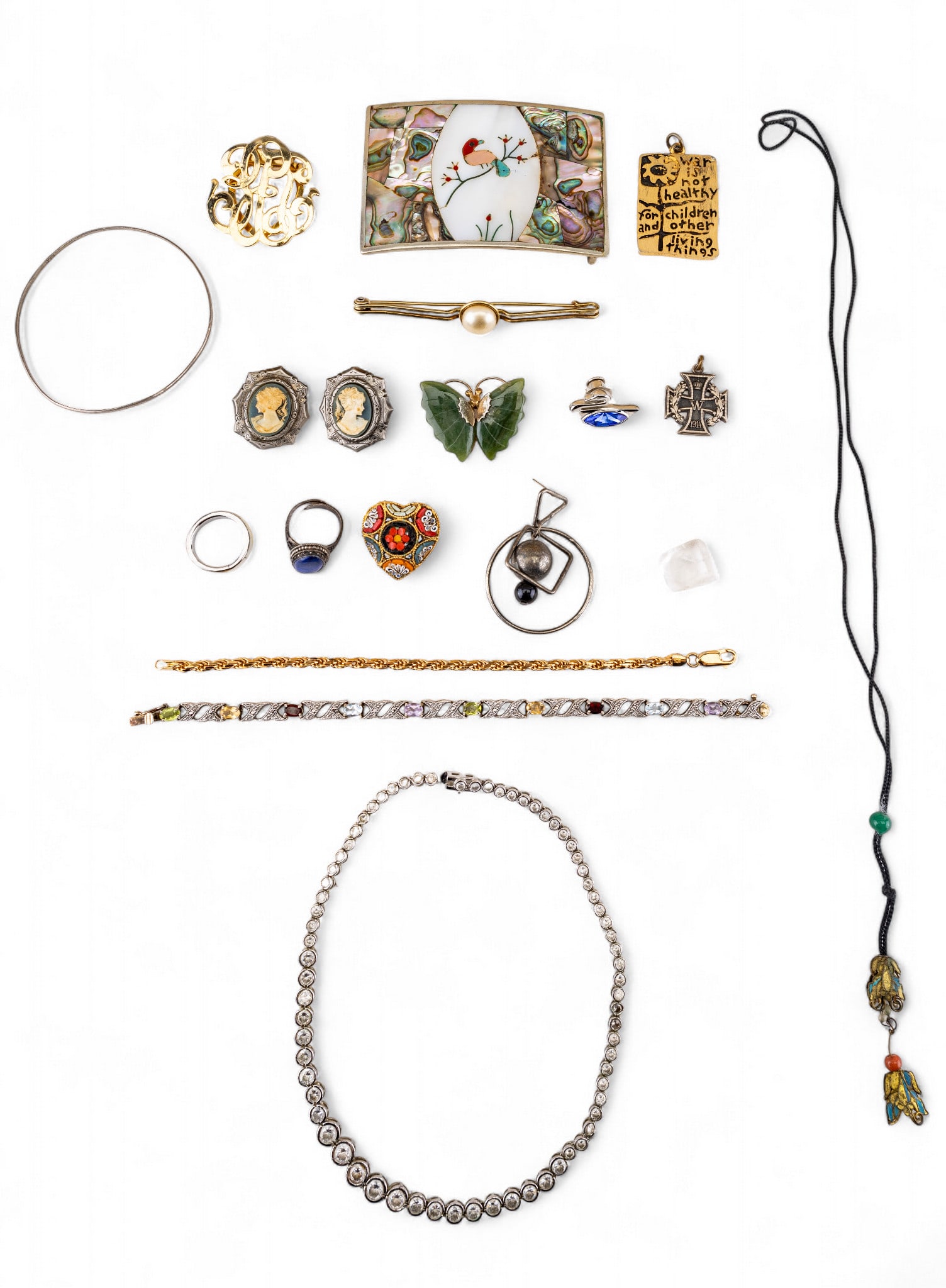 Sterling, Alpaca, and Other Jewelry: Alpaca silver belt buckle with mother of pearl, coral, and turquoise inlay, a sterling silver graduated necklace with round white rhinestones, a sterling silver tennis bracelet featuring amethyst, gar