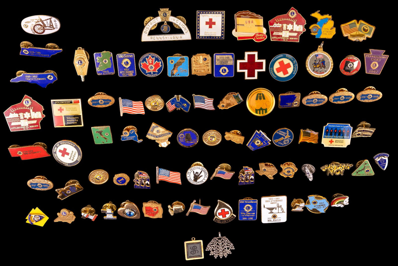 Vintage Pin Grouping: Grouping of vintage American enamel and other pins / lapel pins / advertising. Lions Club and US flags.