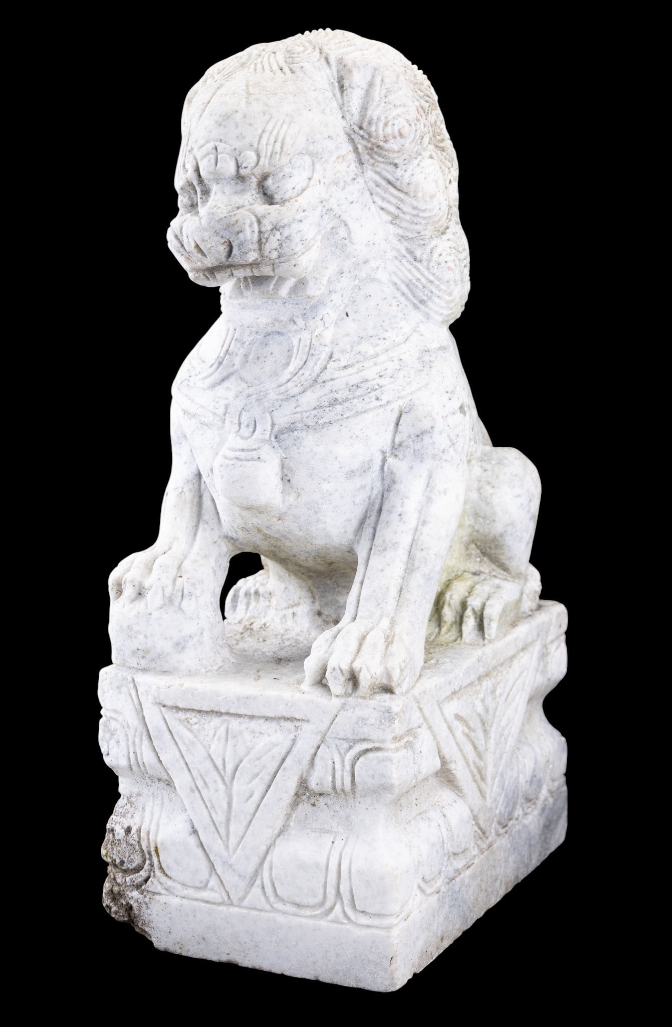 Carved Stone Chinese Foo Dog Statue: Hand carved solid marble Chinese foo dog guardian statue on an integrated plinth base. Features a swirling mane, stylized face, and protective seated pose with one paw over a ball. Measures approx. 19