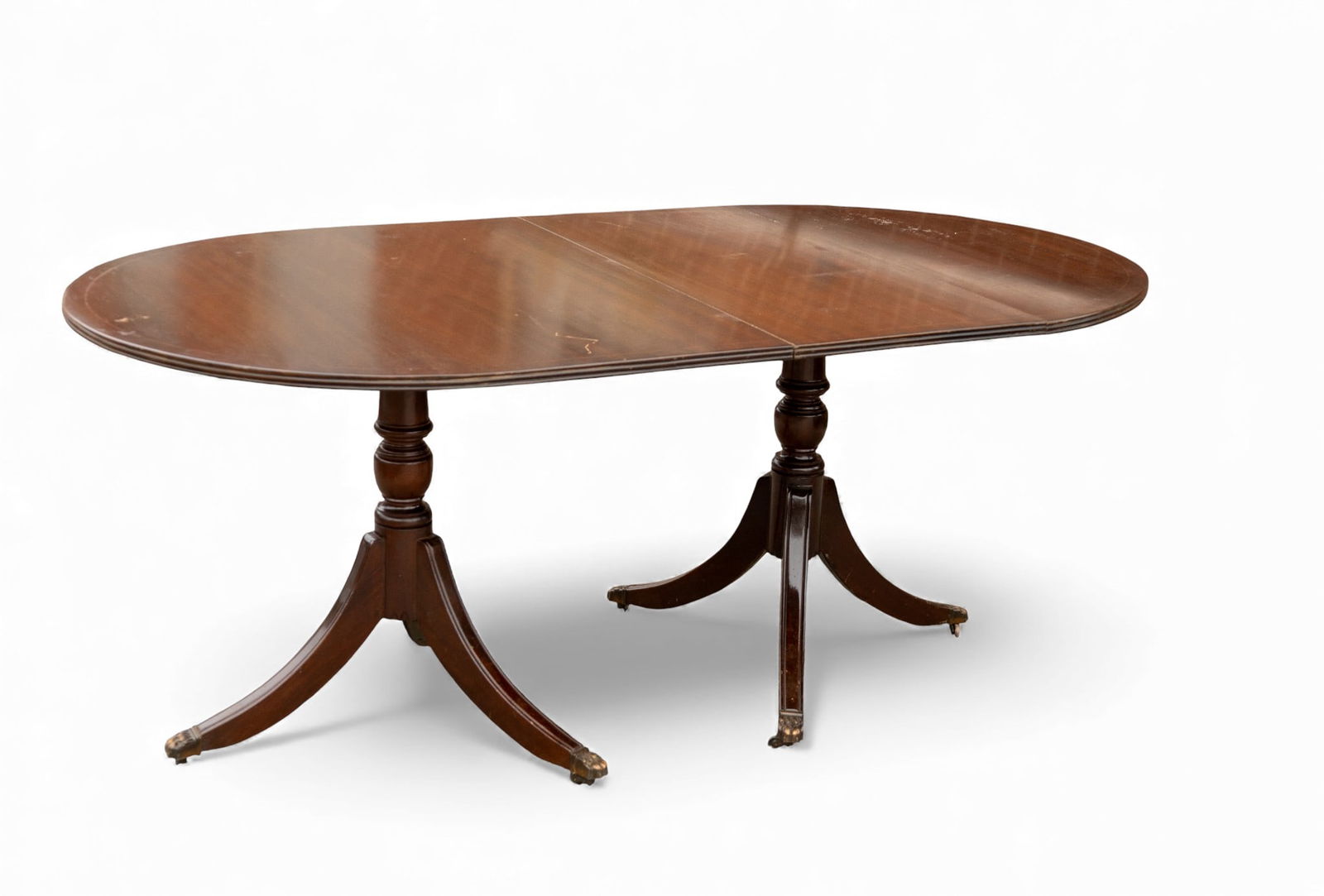 Custom Inlaid Mahogany Dining Table: Custom inlaid Duncan Phyfe style mahogany pedestal dining table, with 1 large leaf. Measures approx. 6' W x 39" D x 29" H (leaf adds 24" in width) 8' wide in total. Paw / claw feet.