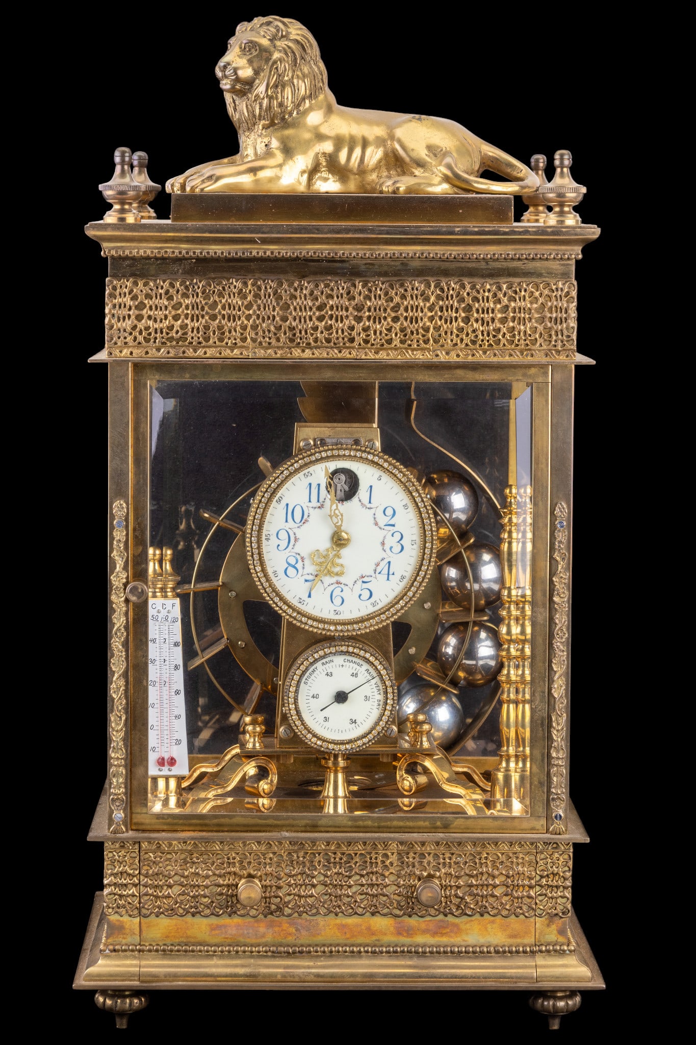 French Falling Ball Ferris Wheel Clock: A grand size and fine French Falling Ball Ferris Wheel table clock, featuring steel balls inserted into the ferris wheel crystal regulator that power the mechanism using gravity, 8-day movement, figur