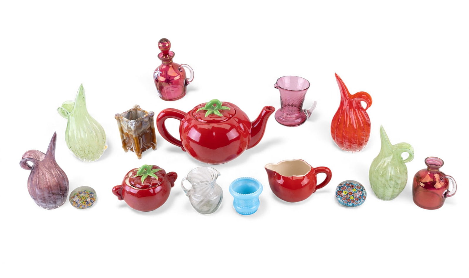 Art Glass & Pantry Parade Ceramic Tea Set: Mixed lot including an assortment of art glass pieces, a 5 piece Pantry Parade tomato-form ceramic tea set, 2 millefiori art glass paperweights, a small square vase, 4 Lefton art glass pitchers/vases,