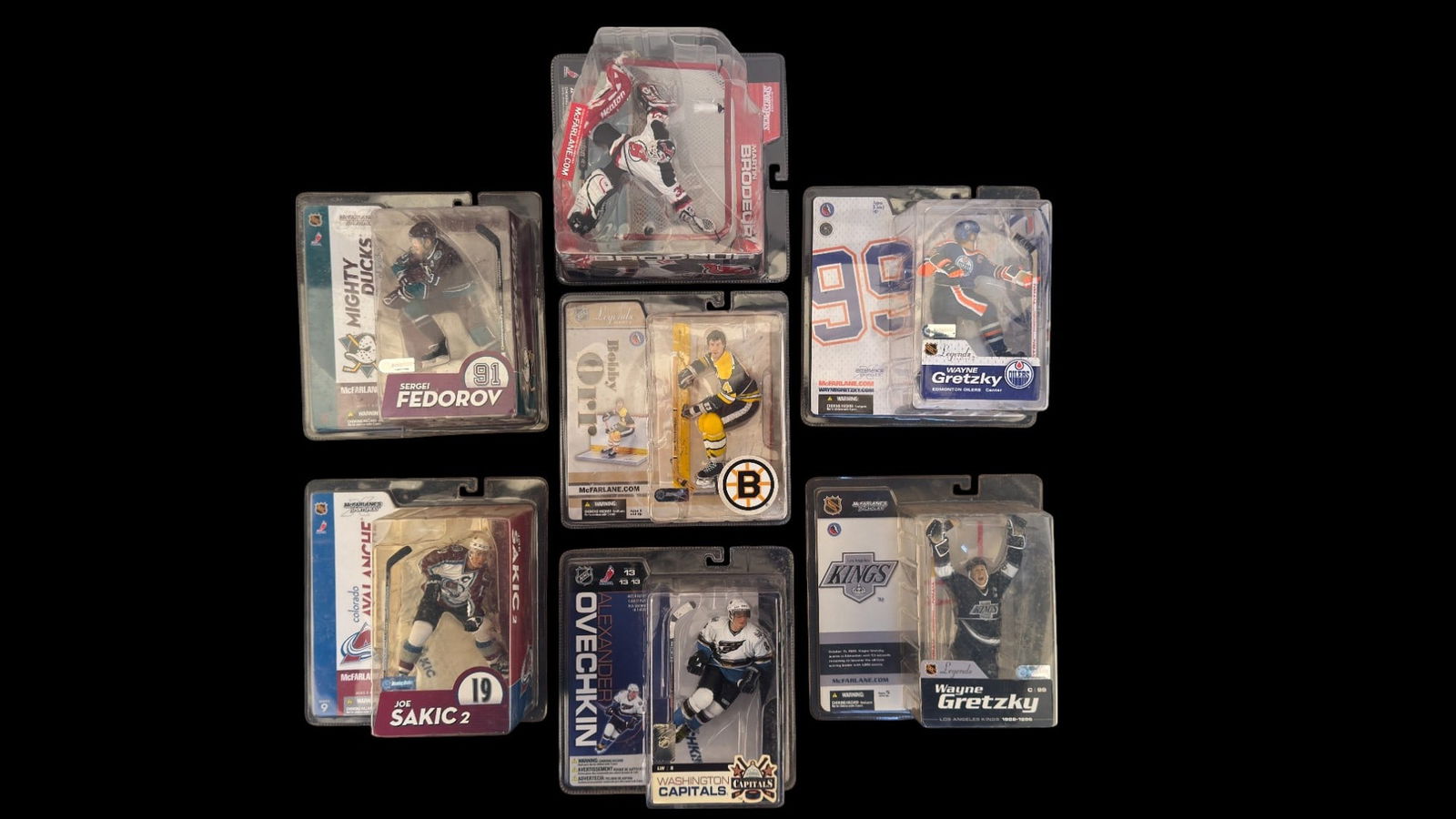 McFarlane NHL Action Figures: Six McFarlane NHL-licensed hockey player action figures, sealed in original retail packaging. Players featured are Joe Sakic (Colorado Avalanche), Wayne Gretzky (Edmonton Oilers and Los Angeles Kings,