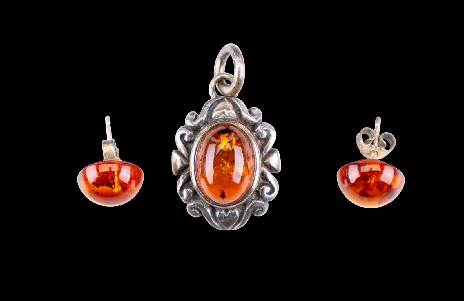 Amber and Sterling Jewelry: Baltic Amber and Sterling silver pendant and a pair of sterling and amber studs.