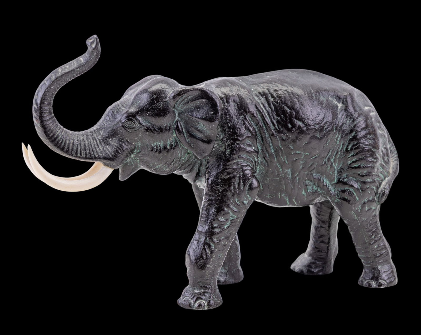 Bronze Elephant with Natural Material Tusks: A bronze elephant statuette featuring tusks made from natural material, note left tusk is loose, measures approx. 6" H x 9" L.