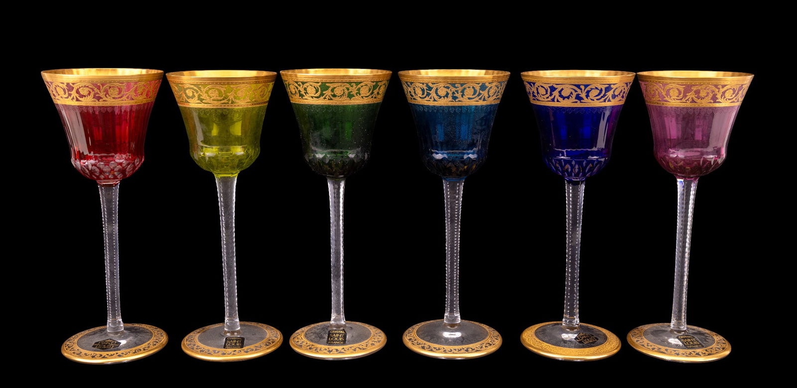 St. Louis Colored & Gilt Wine Glasses (6): Set of 6 St. Louis crystal wine glasses each in a rainbow of colors with gilt rims and feet. Each measures approx. 8" H.
