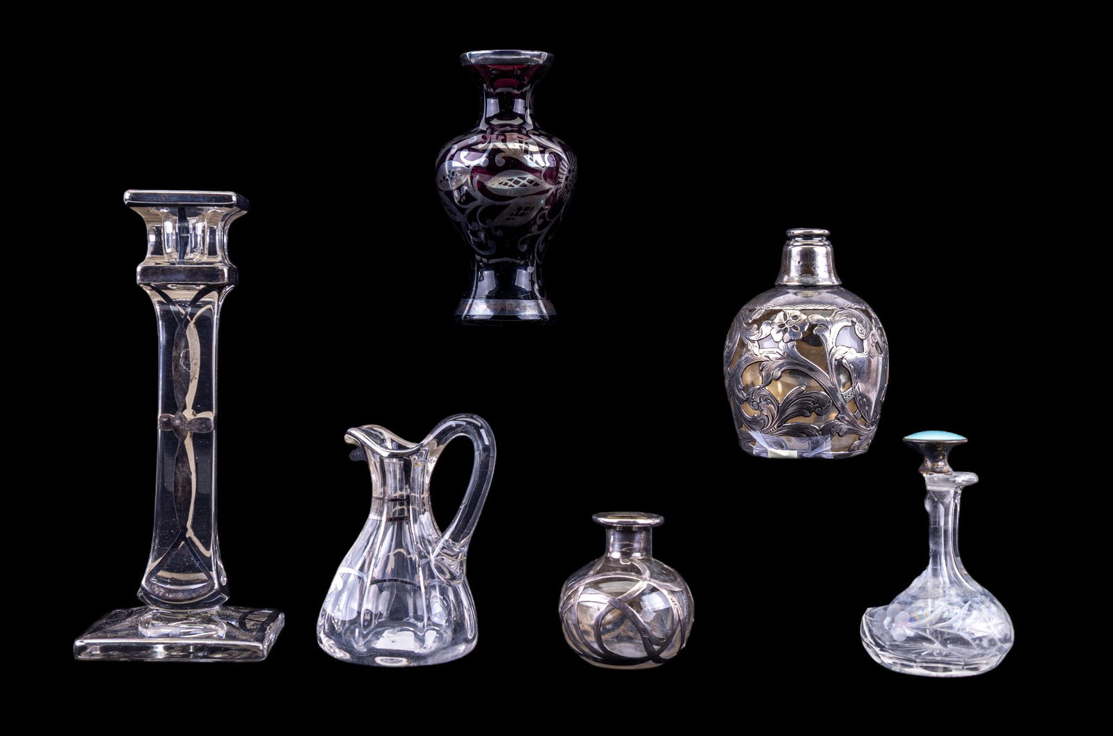 Silver Overlay & Guilloche Perfume & Candlesticks: A collection of silver overlay perfume decanters, purple glass bud vase, cut crystal perfume bottle with guilloche stopper, and a silver overlay candlestick.