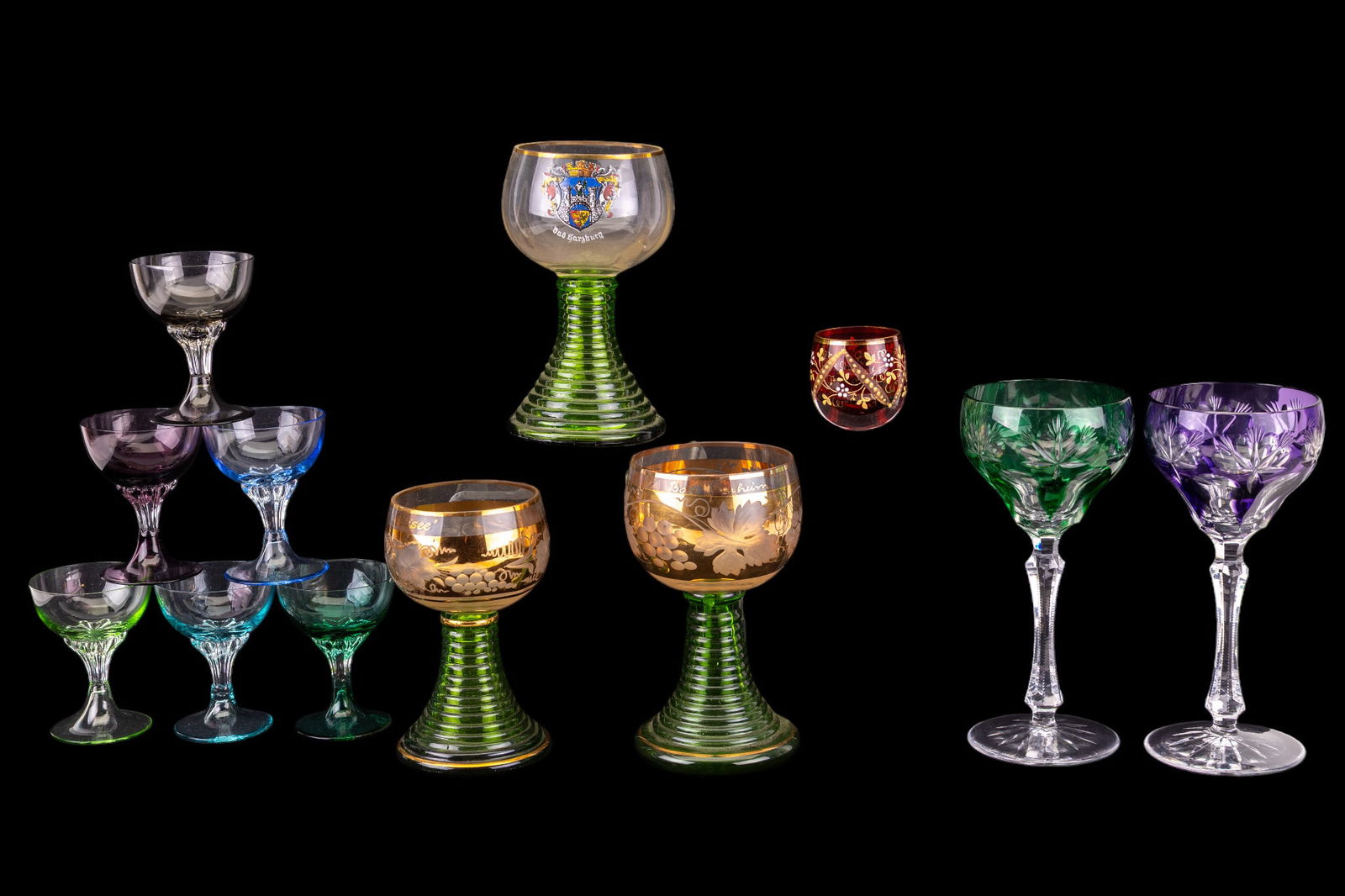 Vintage Bohemian and other Stemware: A collection of vintage stemware including Rohemer ribbed stem glasses, purple and green Bohemian cut crystal wine glasses, a set of six multicolored cordial glasses, and a hand painted cranberry glas
