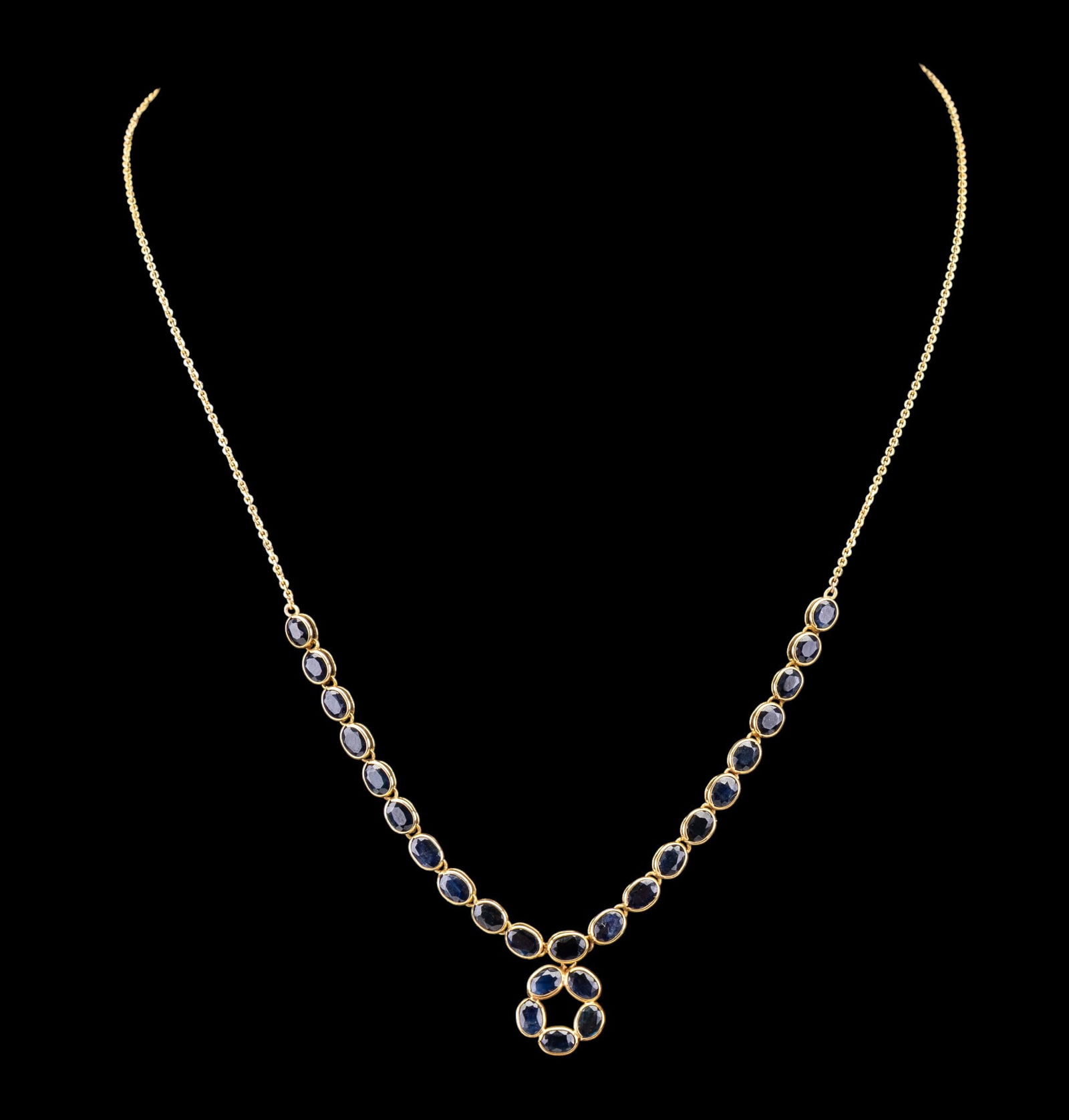 14k Gold and Sapphire Necklace: 14k gold necklace featuring multiple oval sapphire stones set in gold bezels. The necklace has a 9.25-inch drop and a total weight of 5.5 grams.