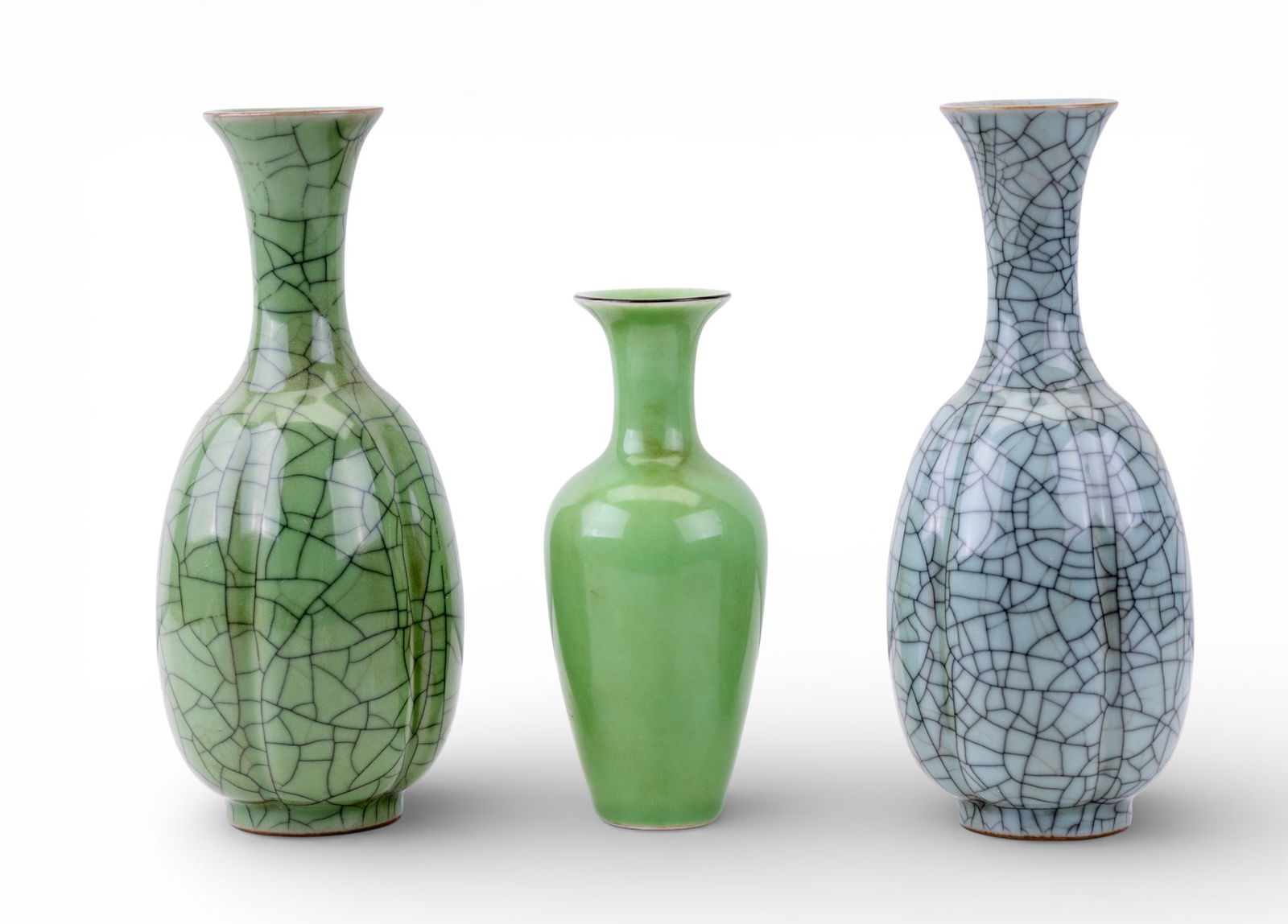Chinese Porcelain Celedon Glazed Vases (3): Three Chinese porcelain vases featuring a celadon green glaze, two of which featuring crazing, all have raised chop marks on the bottom, sizes range from 6.5" to 8.5" H.