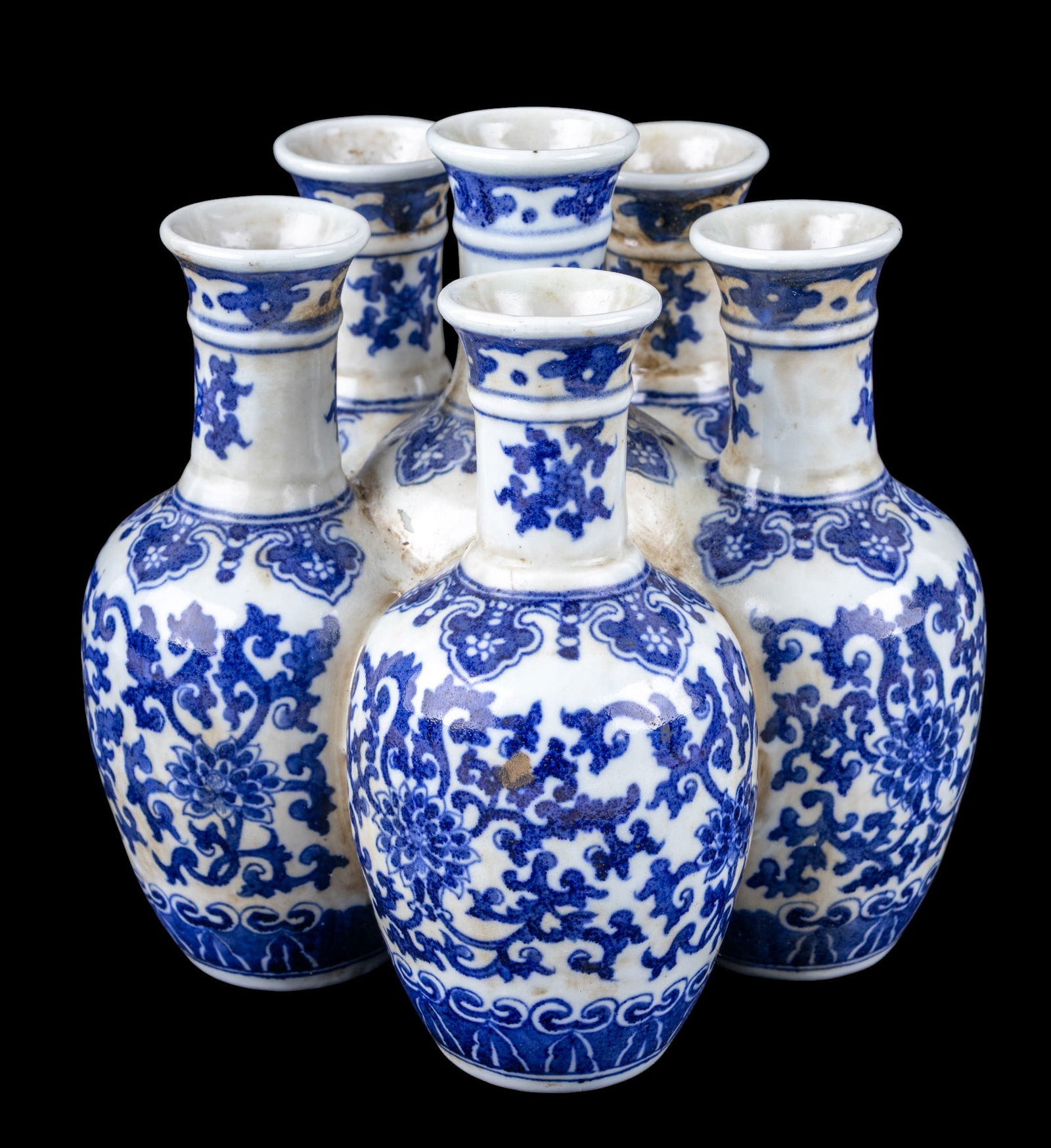 Chinese Blue & White Tulipiere Bud Vase: A Chinese blue and white glaze porcelain tulipiere bud vase featuring six fluted openings, Qing six-character mark on the bottom, measures approx. 8" W x 8" D x 8.5" H.