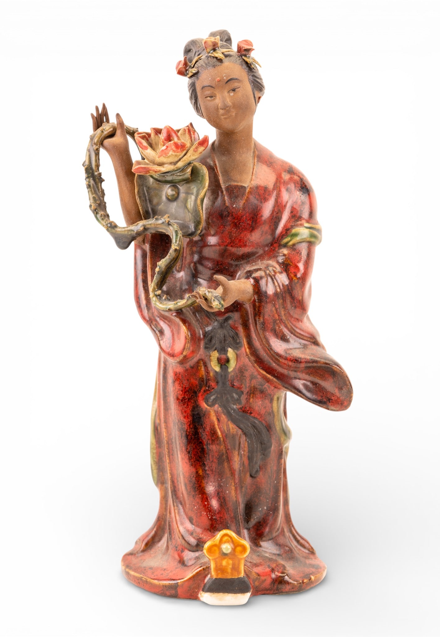 Chinese Shiwan Porcelain Guanyin Statuette: A Chinese Shiwan porcelain statuette depicting Guanyin holding a lotus flower and lily pad, raised chop mark is on the inside of the base, measures approx. 12" H.
