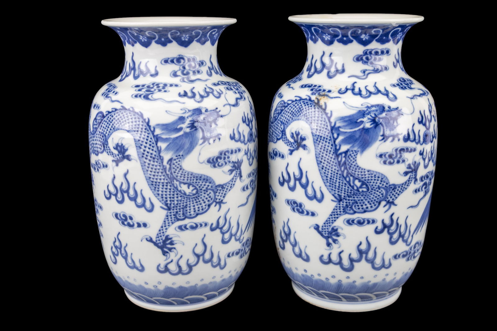 Pair of Chinese Blue & White Porcelain Vases: A matched pair of Chinese blue and white porcelain vases, each decorated with phoenix and dragon motifs. Both pieces bear Qianlong seal marks on the base. Each measures approx. 8" H.