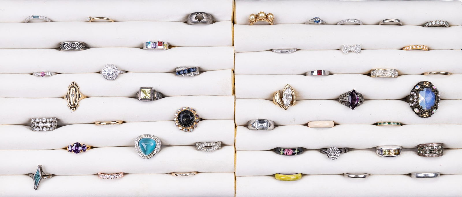 Costume Rings: A collection of 43 costume rings featuring facet cut rhinestones, turquoise chip inlay, lucite, and enameled design elements. Some are adjustable but most siozes range from 4 to 11.5.