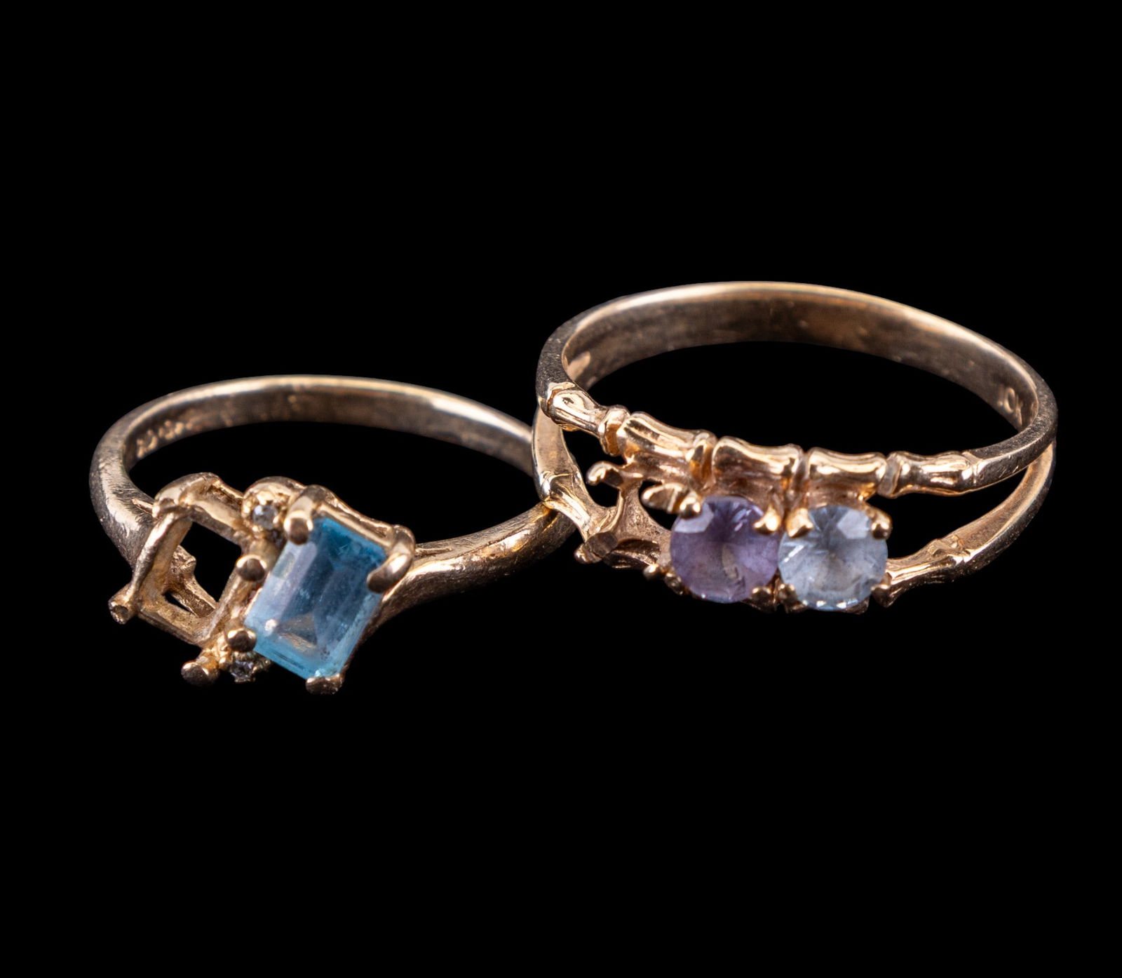 10K Yellow Gold Rings (2 Pc.): Two 10K yellow gold rings. First is made to house 3 stones with a topaz & an aquamarine present (missing one stone), and second is made to house two stones with a topaz present (one stone missing). Ri