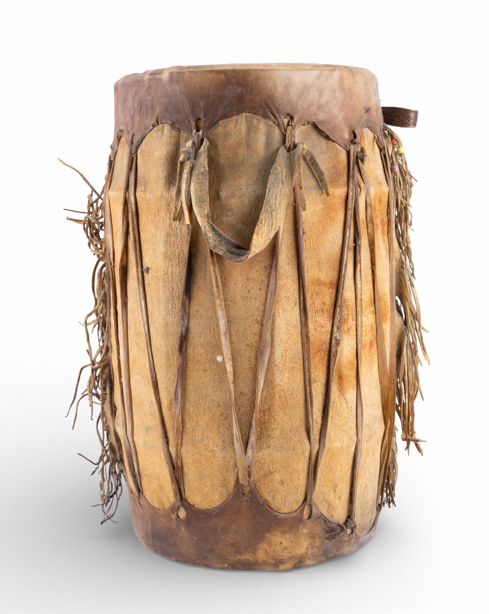 Chochiti Pueblo Hand Drum: Vintage Chochiti Pueblo hand drum constructed with a hollowed wooden body and rawhide drumhead, secured with lacing running vertically along the sides. Measures approx. 18" H x 10" diameter. Condition