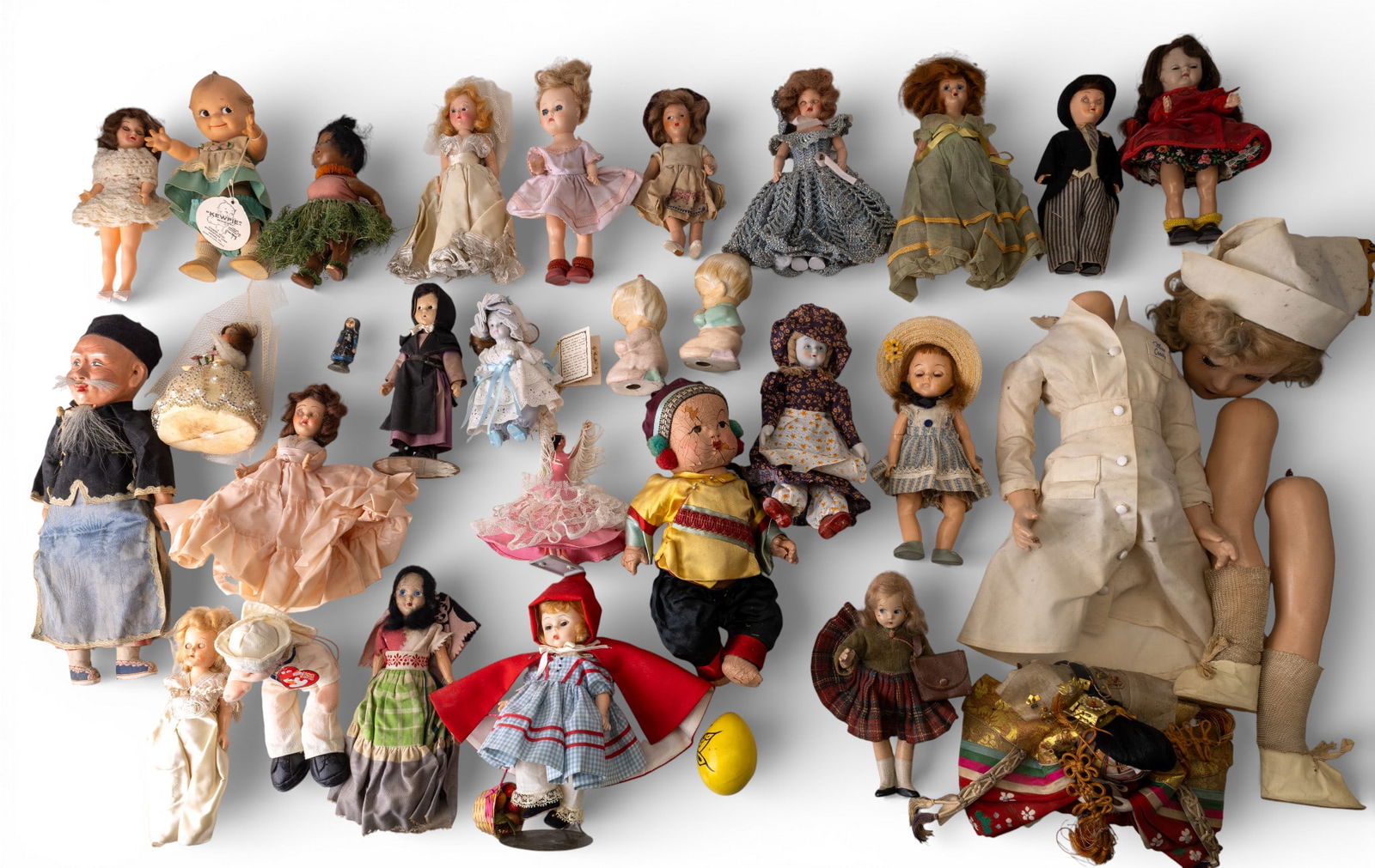 Vintage and Antique Dolls: A collection of vintage and antique dolls including Red Riding Hood by Madame Alexander, a vintage Kewpie Doll with tag, Amish doll, antique sawdust dolls, and more.