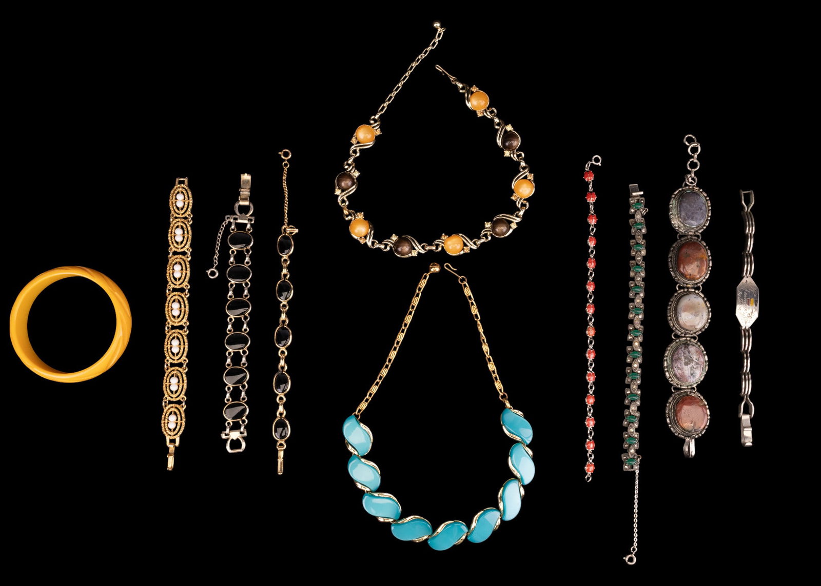 Lisner and Other Vintage Costume Jewelry: A collection of vintage costume jewelry featuring a vintage Lisner gold tone and blue lucite necklace, a souvenir bracelet fro Belgium, a Bakelite bangle, an agate cabochon panel bracelet, an enamel l