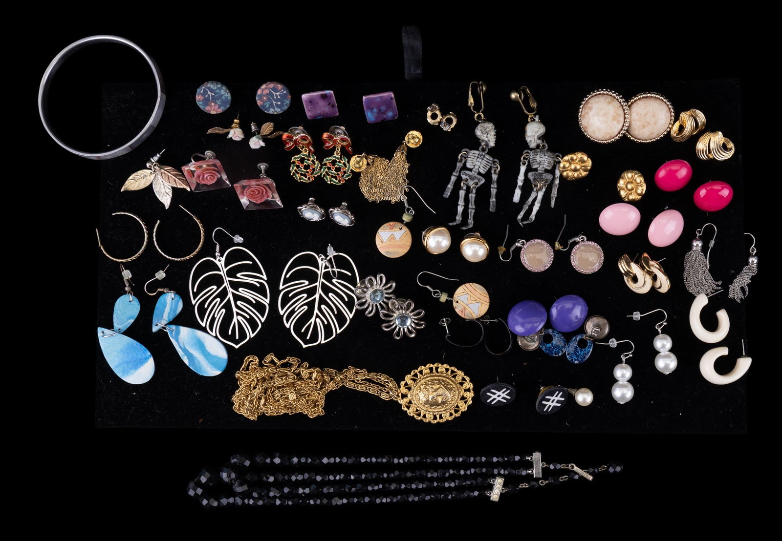 Costume Jewelry, Fashion Jewelry Earrings: Grouping of costume jewelry earrings including Trifari gold tone enamel earrings, figural skeleton earrings, faux wedgewood, resin floral earrings, Laguna black crystal necklace, and more.