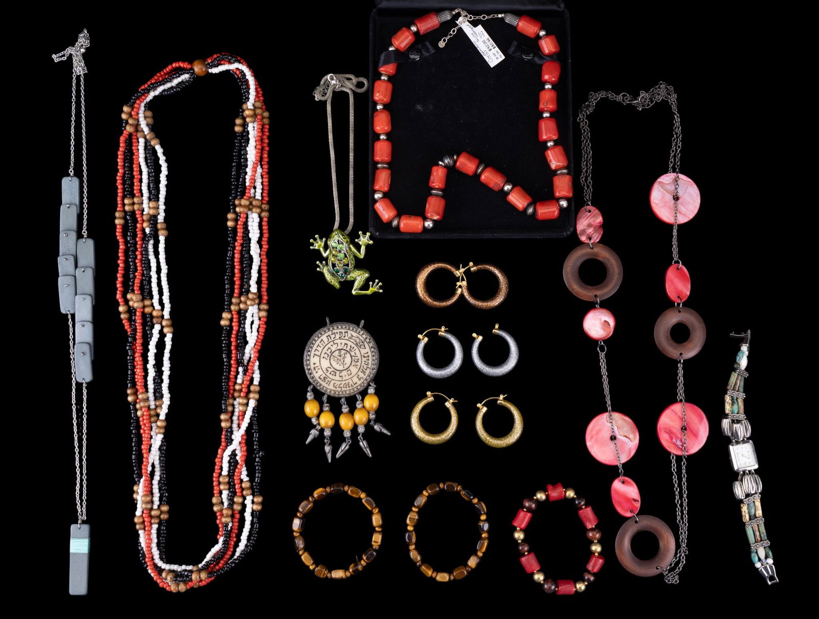 Coral, Sterling, & Costume Jewelry: Jewelry lot including a coral bead necklace marked ?sterling silver,? featuring silver spacers, alongside a variety of other items such as a frog pendant on a chain, colorful beaded necklaces, earring