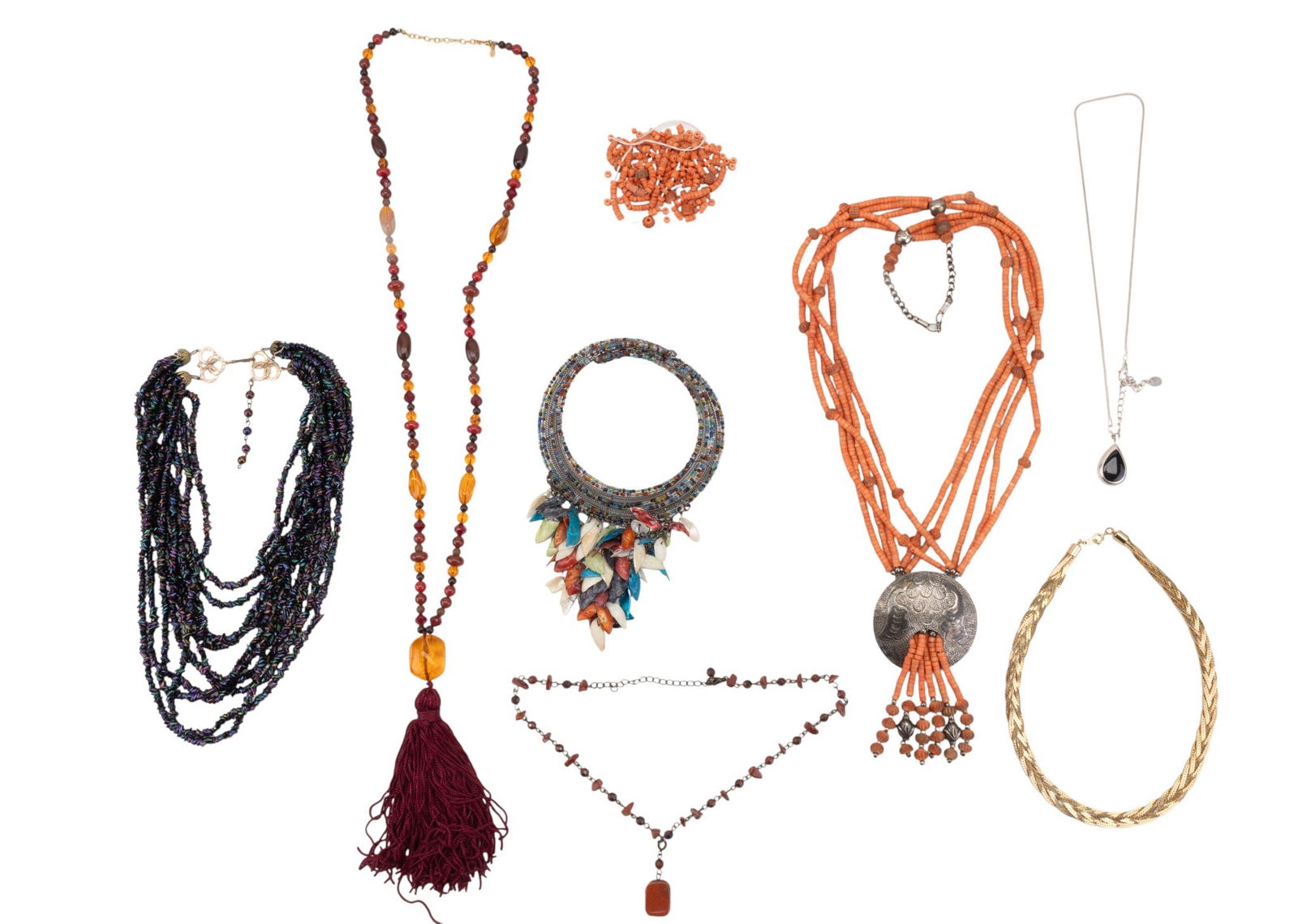 Shell, Stone, and Glass Bead Necklaces: A collection of vintage necklaces featuring dyed puke shell multistrand necklace with etched silver tone pendant, tumbled red jasper necklace, multistrand black peacock carnival glass bead necklace, b