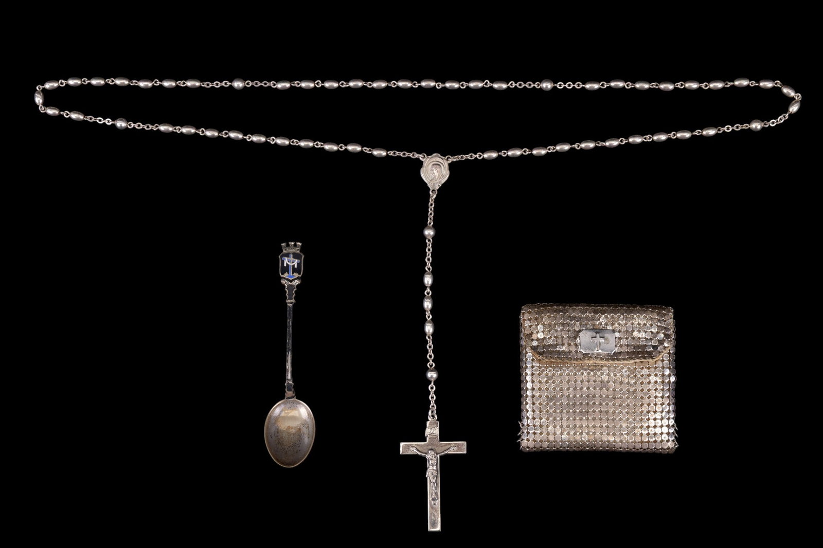 Sterling Silver Rosary and More: A sterling silver beaded Rosary, a Whiting and Davis silver tone metal mesh Rosary pouch, and an 835 purity enameled German souvenir spoon.