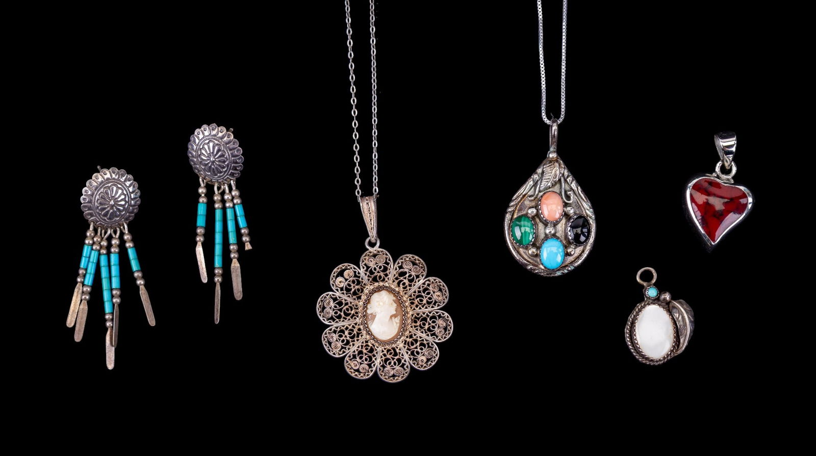 Native American and Cameo Sterling Jewelry: A collection of sterling jewelry including a Native American style pendant with malachite, coral, turquoise, and onyx cabochons, a Native American style pendant with mother of pearl, a pair of Navajo