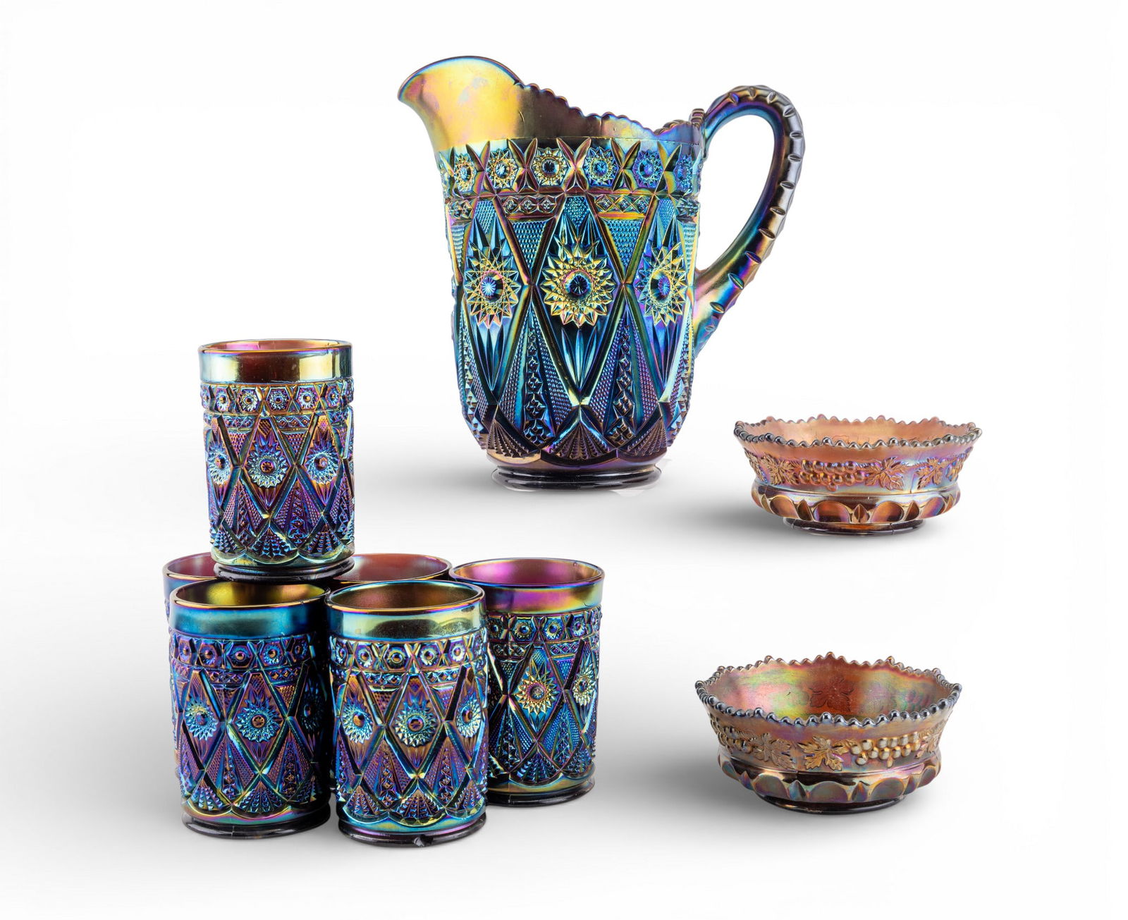 Molded Carnival Glass Water Set (7 Pcs): Imperial Diamond & Lace amethyst water set including 1 handled pitcher and 6 matching tumblers, all in the Diamond Lace pattern. Each tumbler measures approx. 4.25" H. Also included are 2 amethyst-col