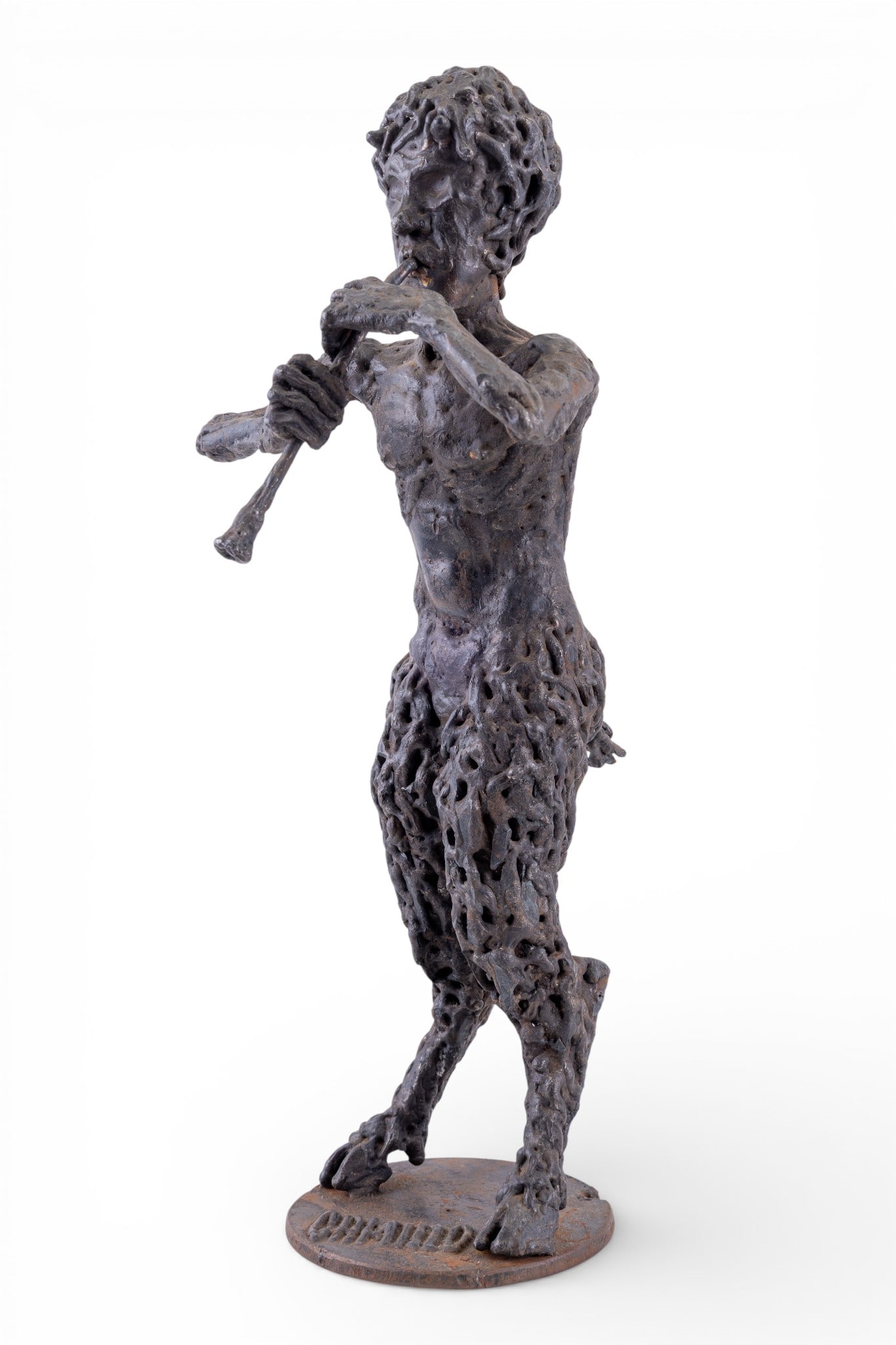 Cast Iron Satyr Sculpture, Camillo: Cast iron figural sculpture depicting a satyr in standing pose, holding a pipe / flute, with textured surface throughout. Figure is signed Camillo in raised lettering on the circular base. Measures ap