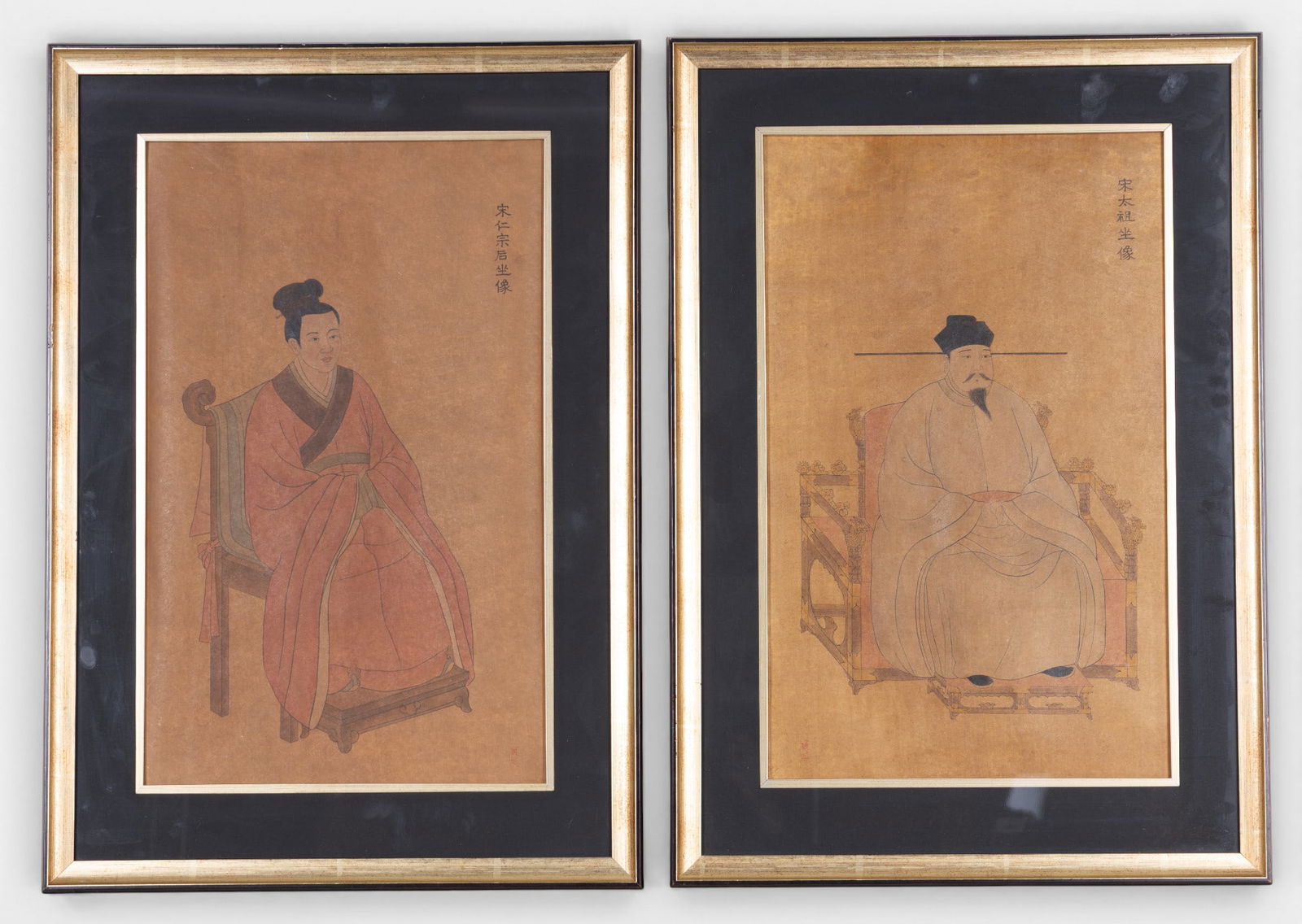 Chinese Emperor & Empress Portraits (2): Matched pair of Chinese figural portrait prints depicting an emperor and empress in traditional court attire, each seated on an ornate chair against a parchment-tone ground with vertical calligraphy t