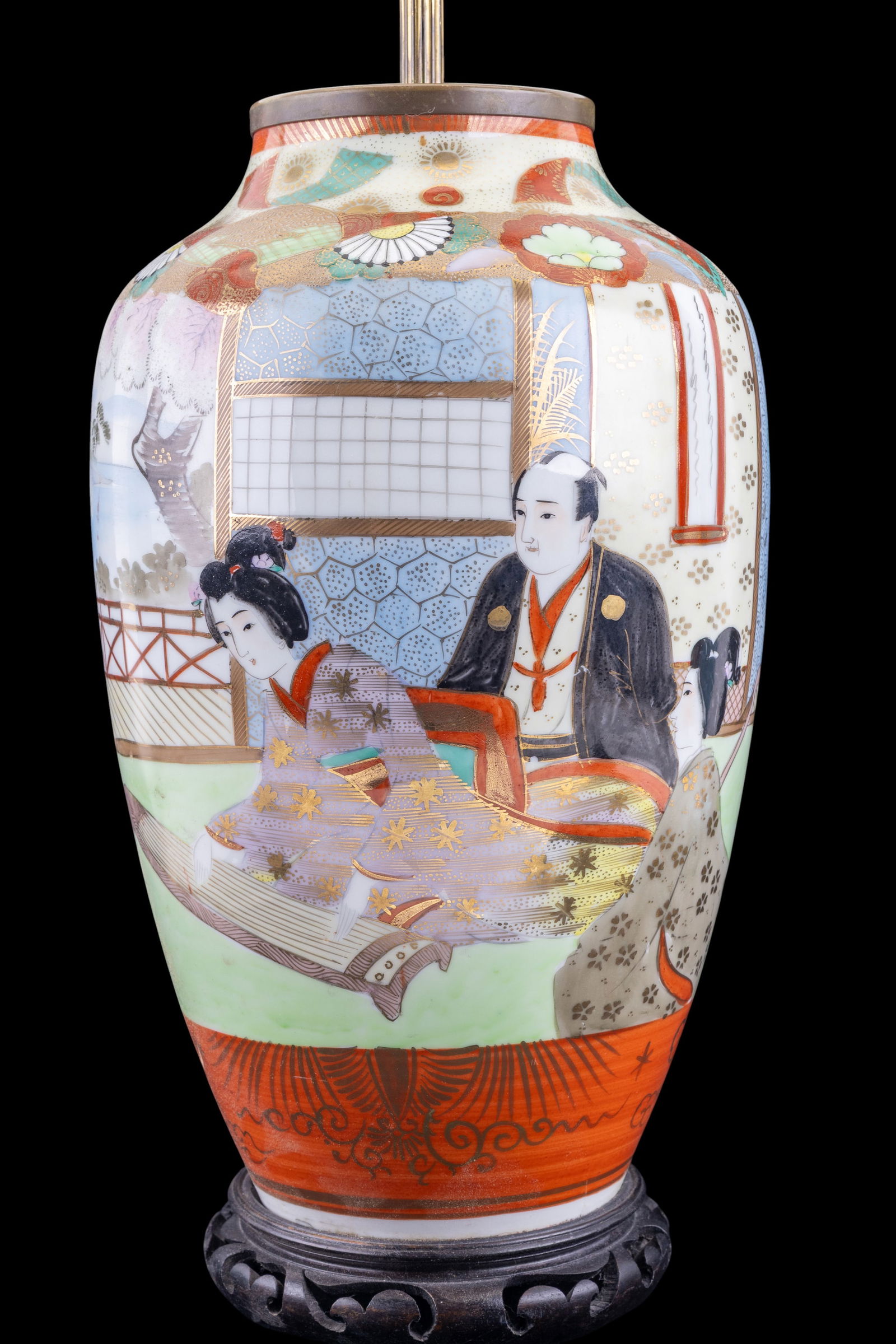 Japanese Satsuma Porcelain Table Lamp: Japanese Satsuma porcelain vase-form table lamp, decorated with figural and landscape scenes in polychrome enamles with gilt accents. Mounted with brass hardware and set on a carved dark wood base. Mu