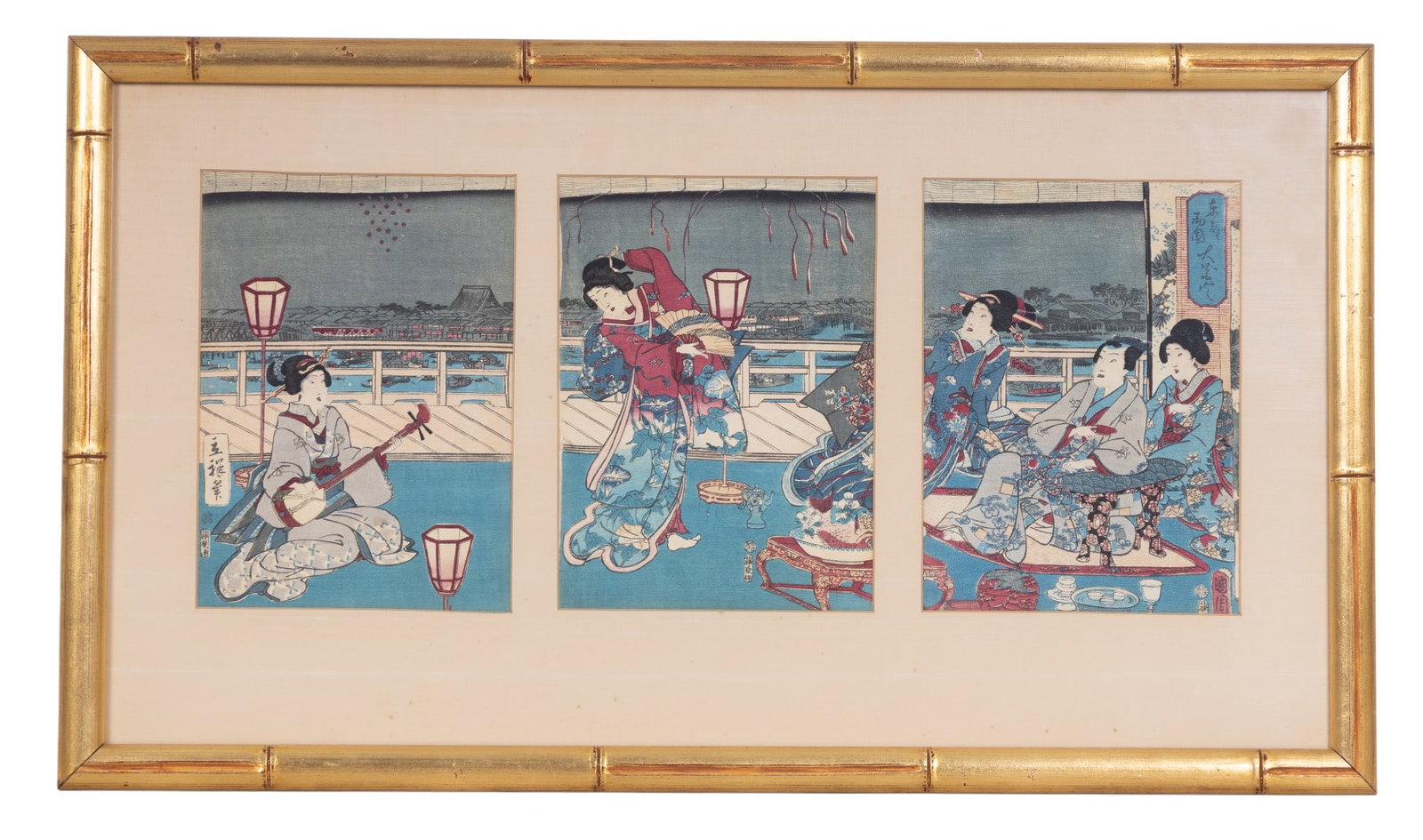 Japanese Woodblock Attr. Kunisada (1786-1864): A Japanese set of three Edo Ukiyo-e woodblock on fabric triptych prints under a triple-opening mat in a gold painted bamboo style frame depicting Geisha entertaining, attributed to Kunisada Utagawa (J
