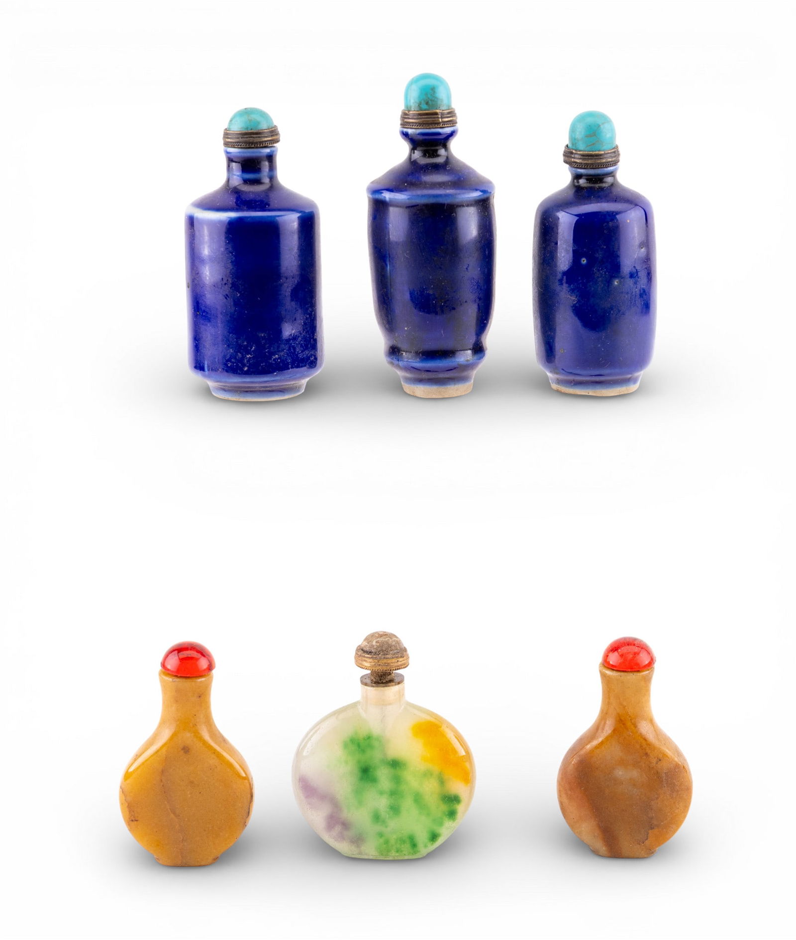 Porcelain and Jade snuff Bottles: A collection of 6 snuff bottles including 3 cobalt blue glazed porcelain bottles with howlite caps, 2 stone bottles, and one multicolored jade bottle. Tallest measures approx. 3.5" H.