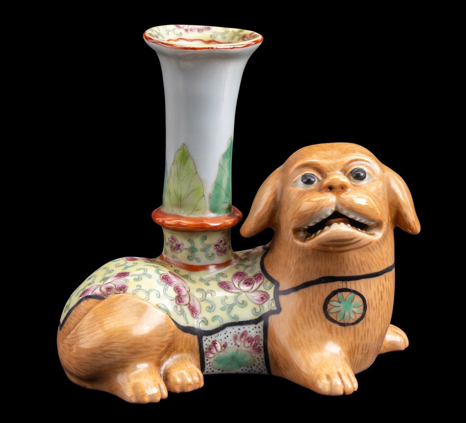 Antique Chinese Famille Rose Foo Dog Candlestick: An antique Chinese Famille Rose foo dog porcelain candlestick, featuring a yellow ground and gold painted fur details, measures approx. 5.5" W x 3" D x 5" H.