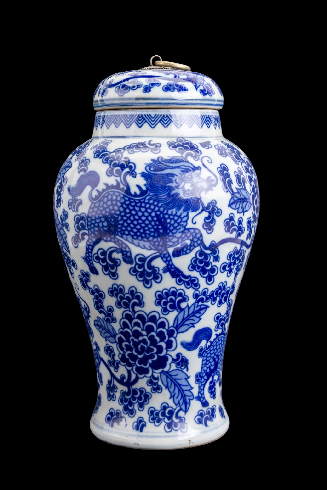 Chinese Blue & White Porcelain Lidded Vase: Chinese blue and white porcelain lidded vase, of baluster form, decorated overall with mythological creature motifs amid foliage and clouds. Lid is fitted with a brass mounted ring finial. Underside b