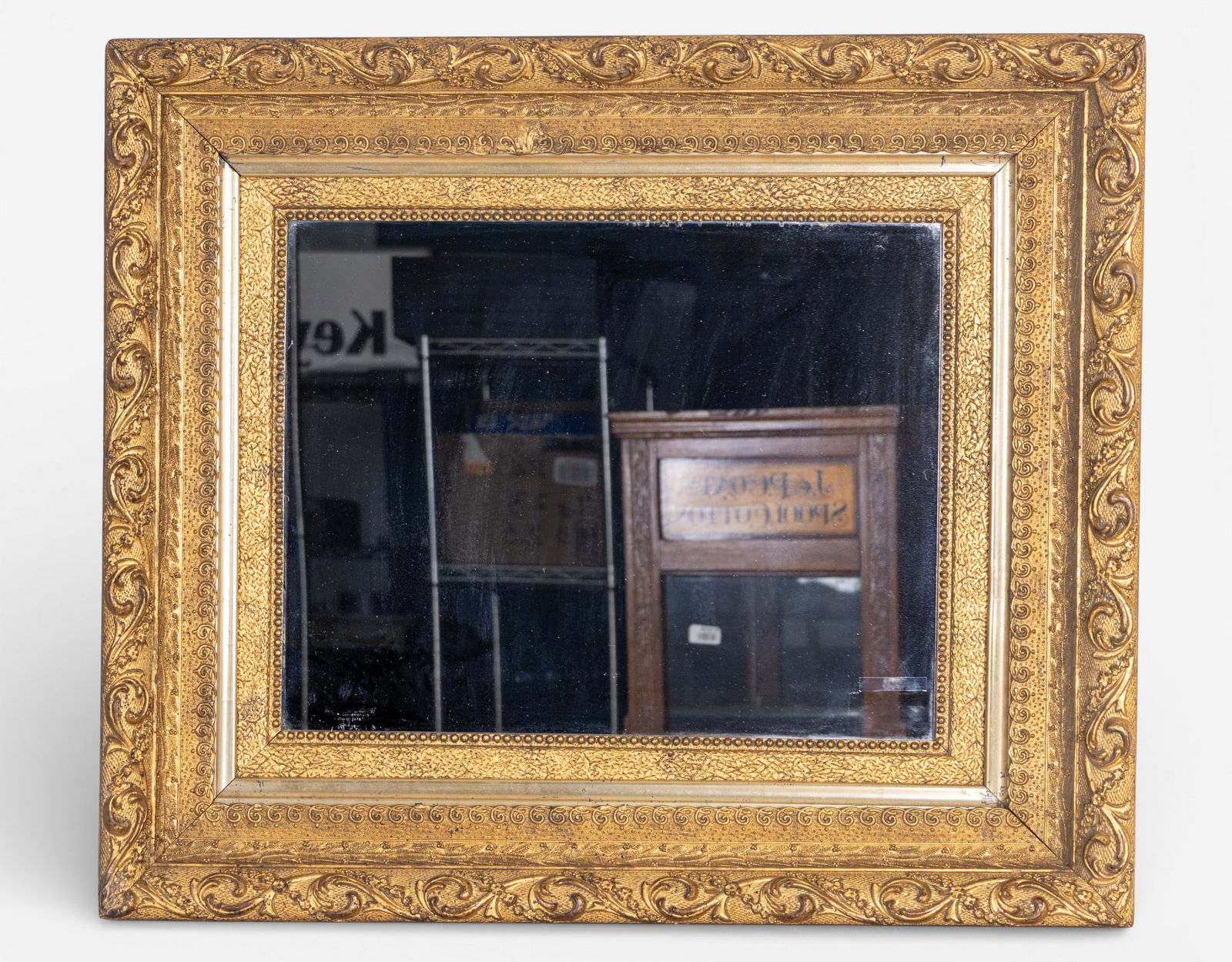 Victorian Carved Gilt Wood Mirror: A fine Victorian carved gilt wood, triple-stacked, framed mirror featuring floral and scroll work designs, c. 1860-80, OD measures approx. 26" H x 31" W