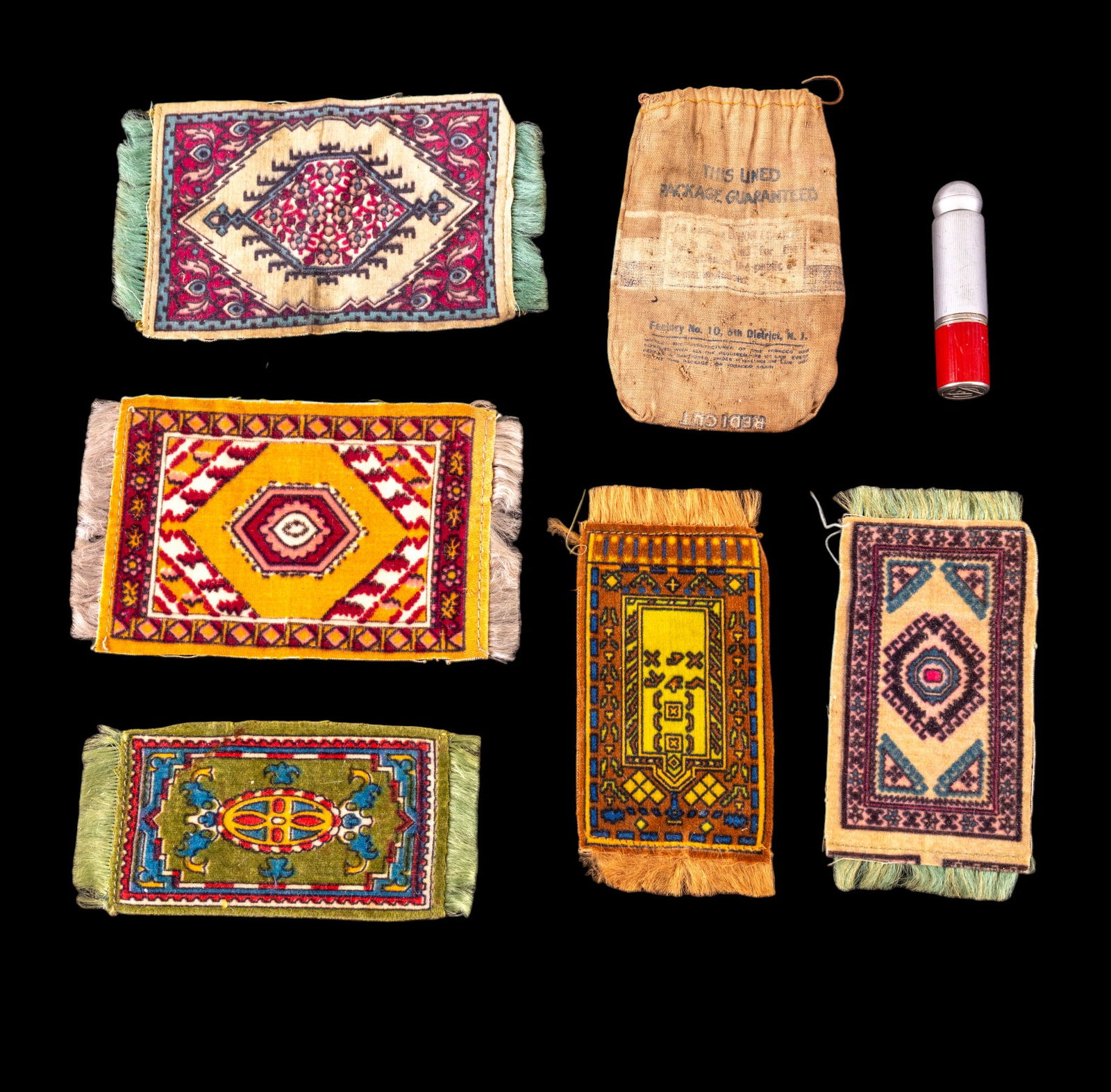 Vintage and Antique Tobacciana: A collection of vintage tobacco silks, an antique tobacco pouch, and a vintage trench style lighter.
