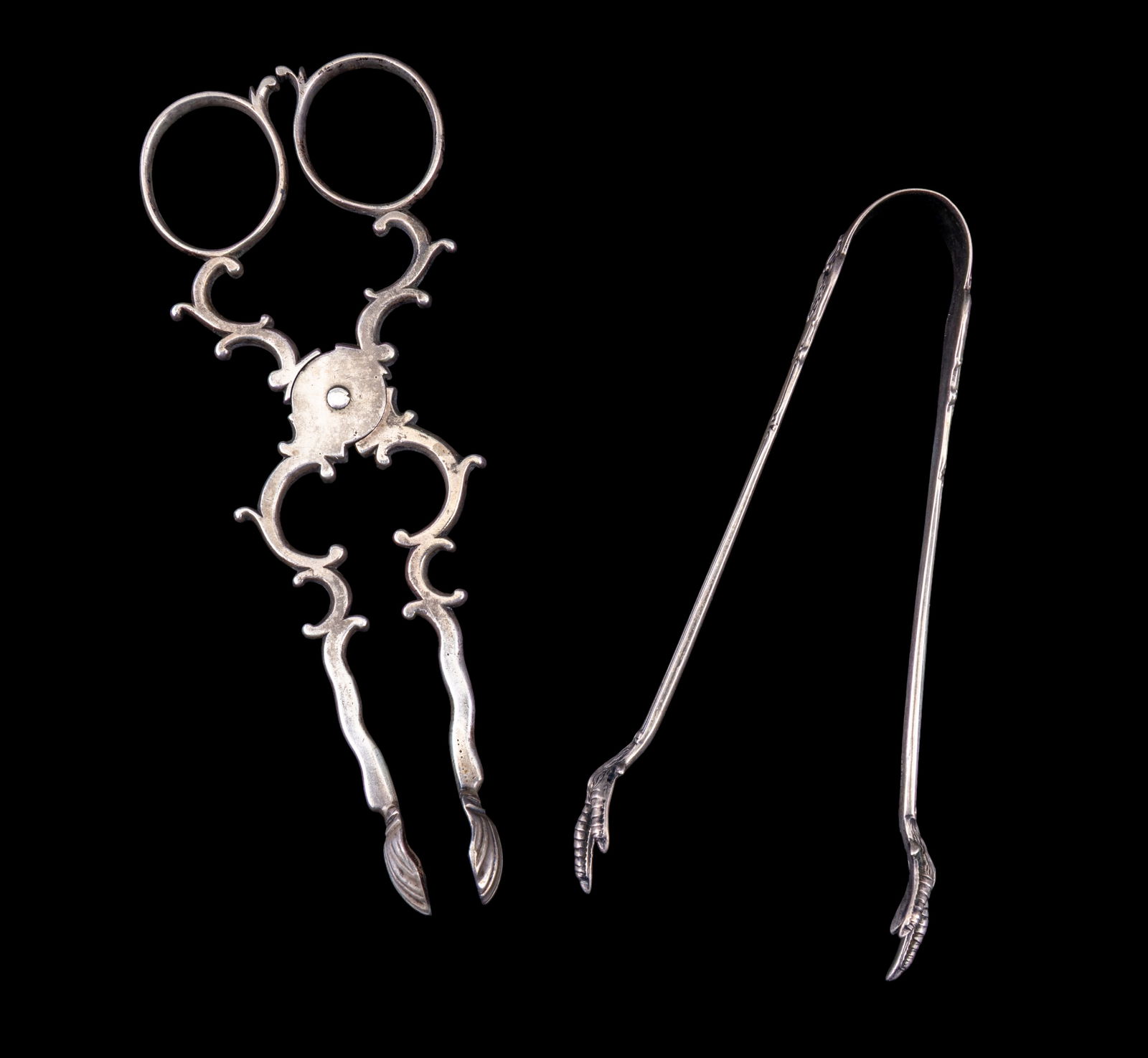 18th & 19th Century Silver Sugar Nibs: Two sets of silver sugar nibs. The 18th-century European provincial sugar nibs feature a scissor form design with shell tips, unmarked but testing for 800 to 830 silver purity, weighing 1.56 ozt and m