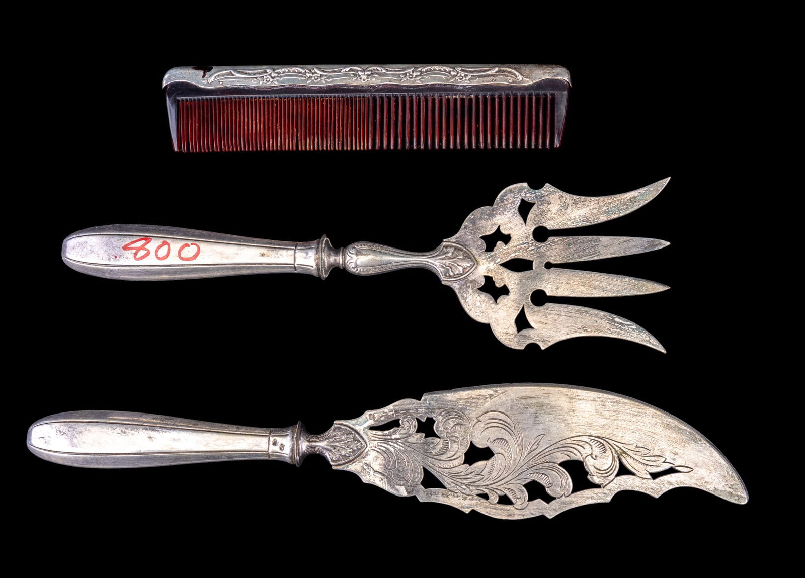 800 and 925 Silver Comb and Utensils: A fine sterling silver edged Gorham comb featuring a floral design, and a fine antique set of 800 silver etched serving fork and fish knife.