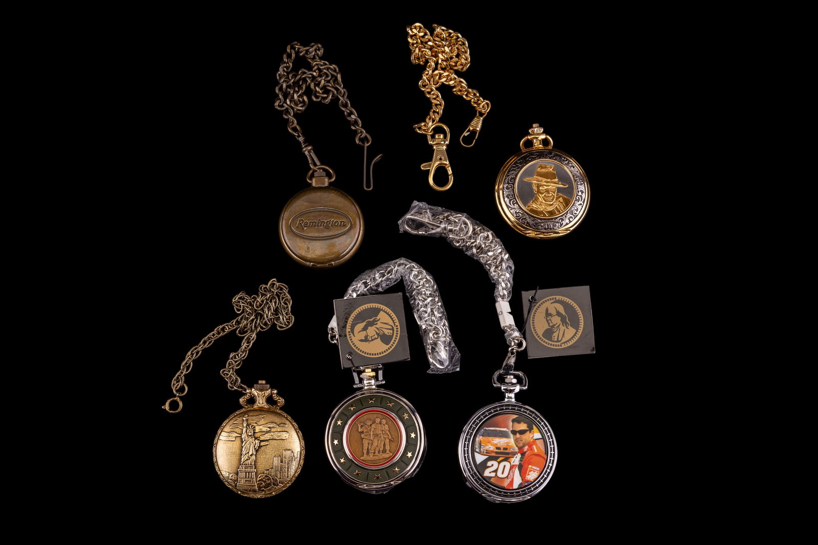 Franklin Mint and Other Collectible Pocket Watches: A collection of commemorative collectible pocket watches featuring a Tony Stewart, UH-1 Huey helicopter, John Wayne, by Franklin Mint, a Statue of Liberty cased and Remington Rifle themes. In as found