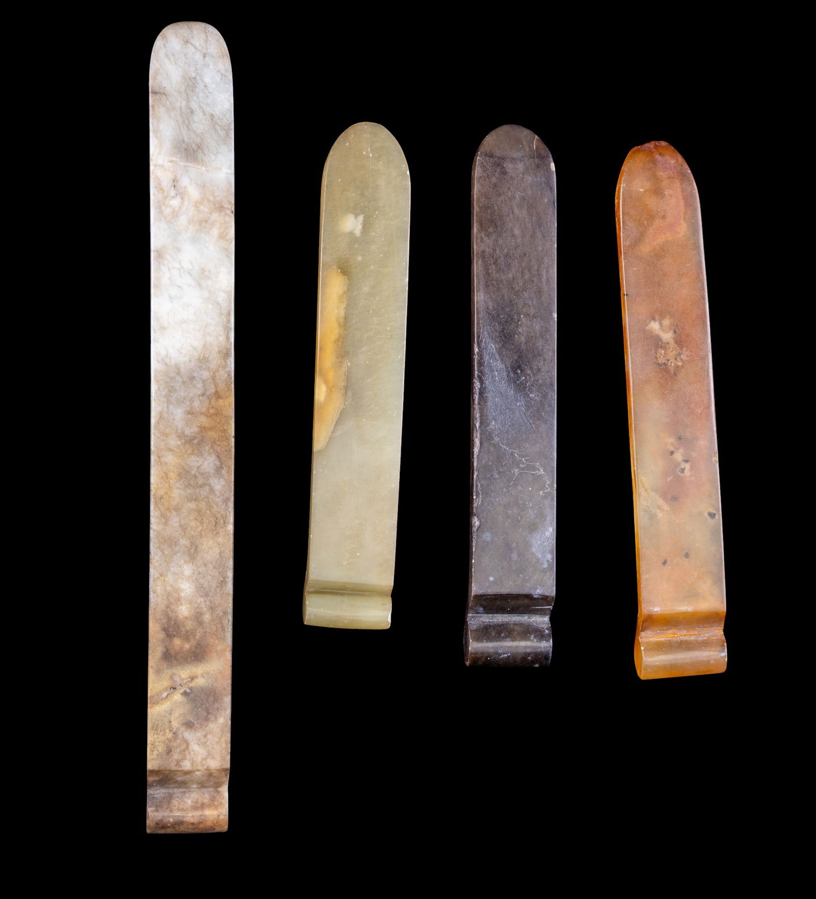 Carved Smooth Stone Hair Pins: Collection of four antique carved stone hair pins.