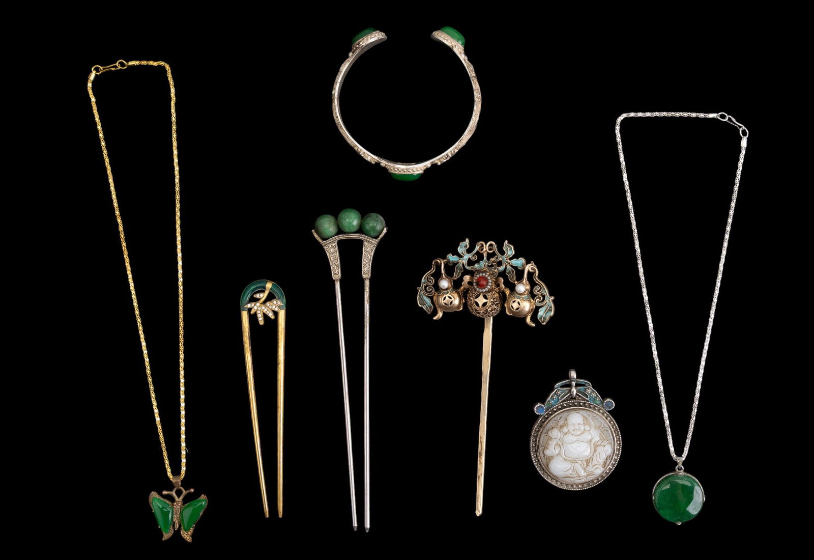 Chinese Jade and Enamel Jewelry: A collection of Chinese jade and enamel jewelry including a cuff bracelet with three dyed green jade cabochons, a gold tone butterfly pendant with jade wings, left wing is dyed, a gold tone hair pin w