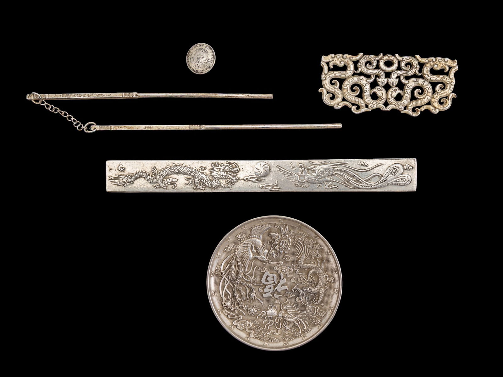 Chinese Silver Tone Hair Chopsticks and More: A silver tone dragon dish, a coin button, a dragon and phoenix scroll weight, hair chop sticks, and a belt ornament.