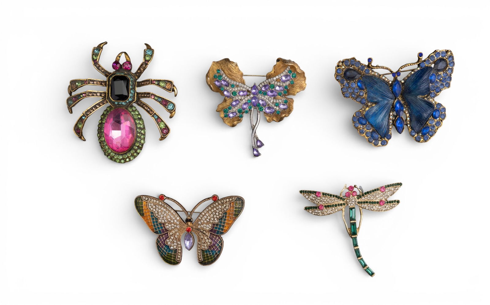 Rhinestone Insect and Spider Brooches: An enamel and rhinestone butterfly brooch, a purple rhinestone butterfly brooch, a blue rhinestone butterfly brooch, a rhinestone dragonfly brooch and a rhinestone spider brooch with large pink
