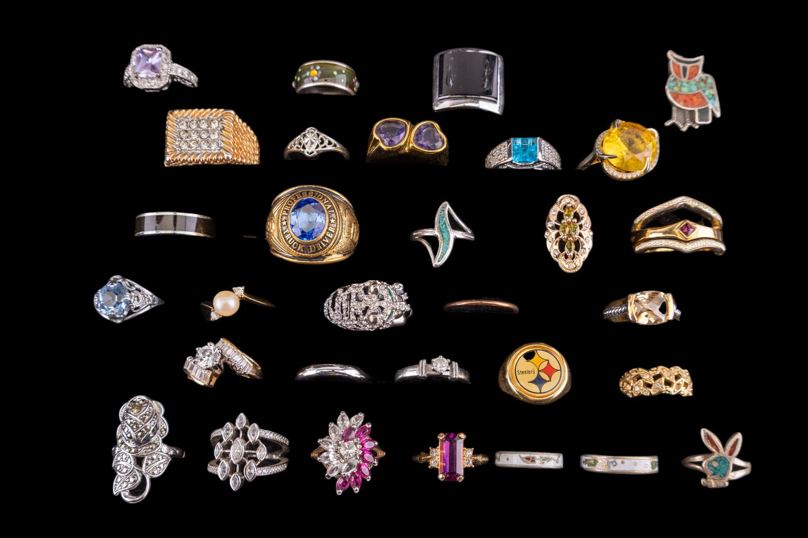 Costume Rhinestone and Inlay Rings (31): A collection of 31 rings featuring rhinestones, turquoise and coral inlay, and enamel featuring an adjustable Pittsburgh Steeler ring, 14K GE pink marquee rhinestone ring, 18K GE bypass ring, white 18