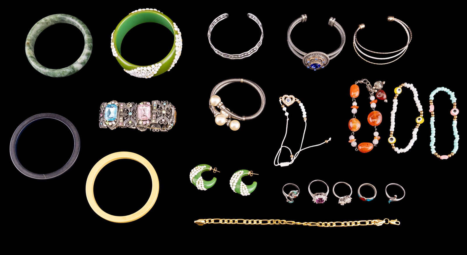 Jade, Bakelite, and Other Bracelets: A collection of bracelets featuring a green Bakelite bangle with matching stud hoop earrings, three turquoise inlay siler tone rings, a carnelian bead bracelet, a jade bangle, diam. approx. 2.25" W, y